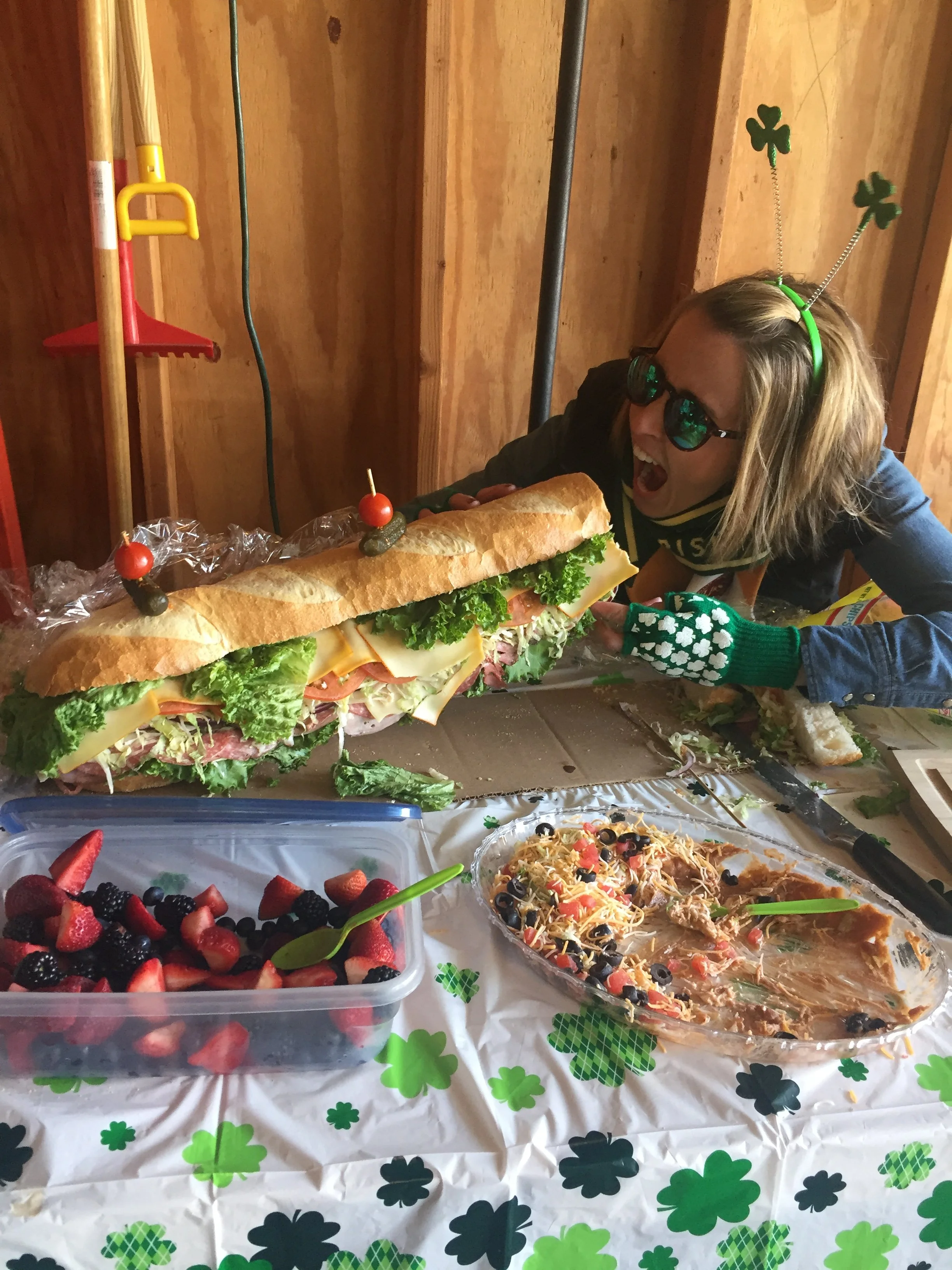 Jayme Rae Forker Schwartz eating a giant sandwich