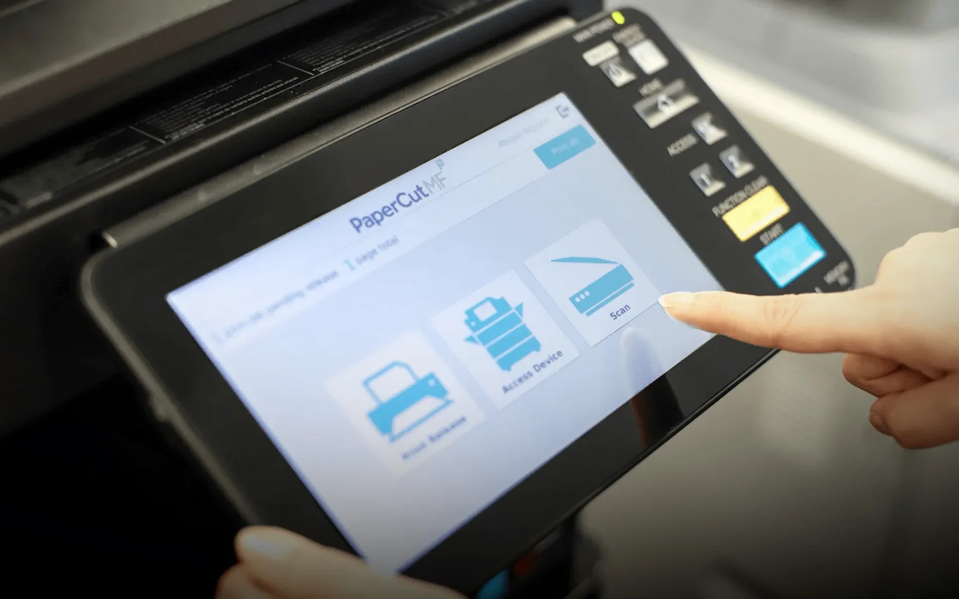 Close-up of a person's finger pressing a button on a touchscreen printer control panel, displaying options for printing and scanning.