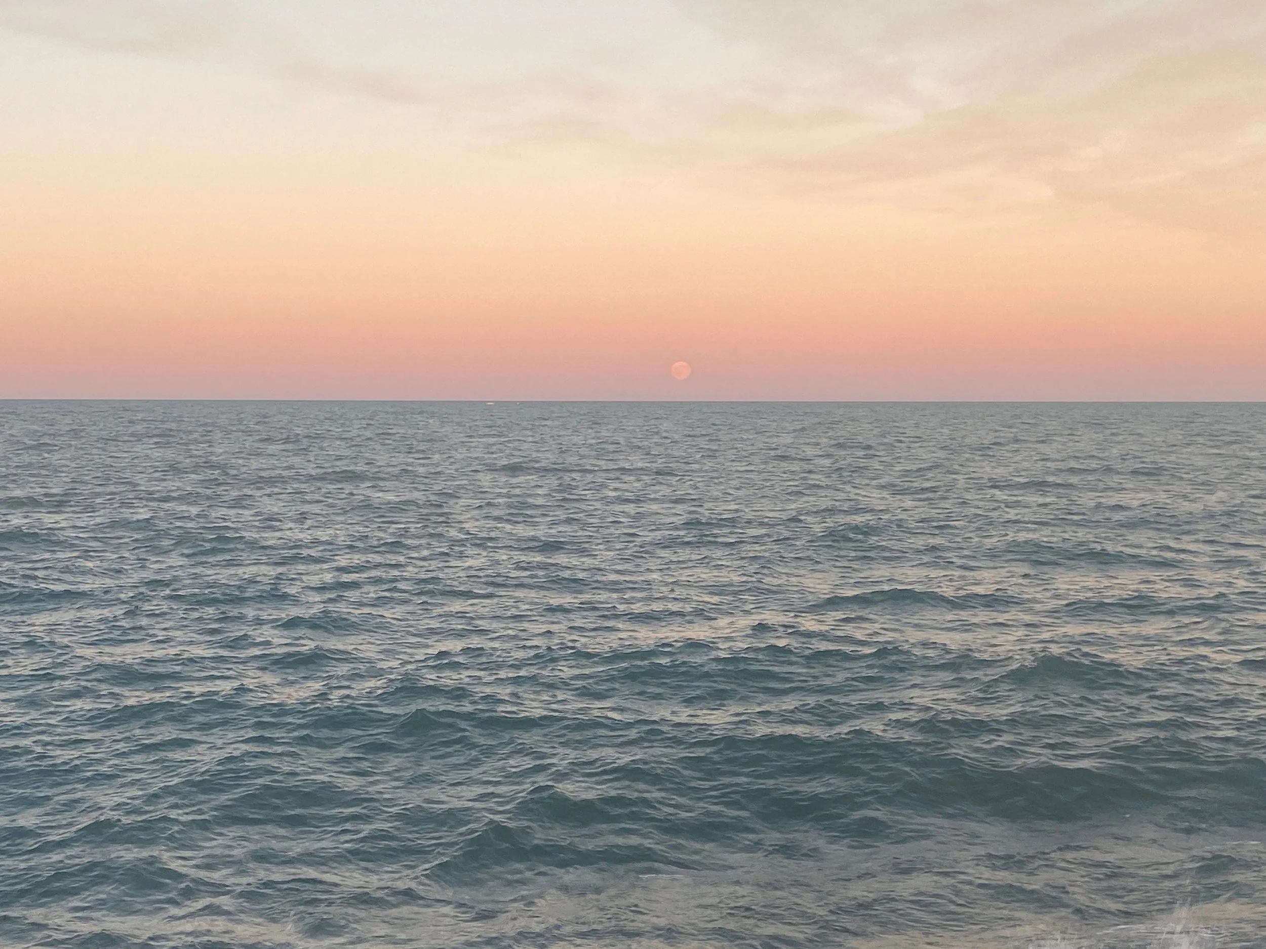 Sunset over Lake Michigan with pink and orange sky