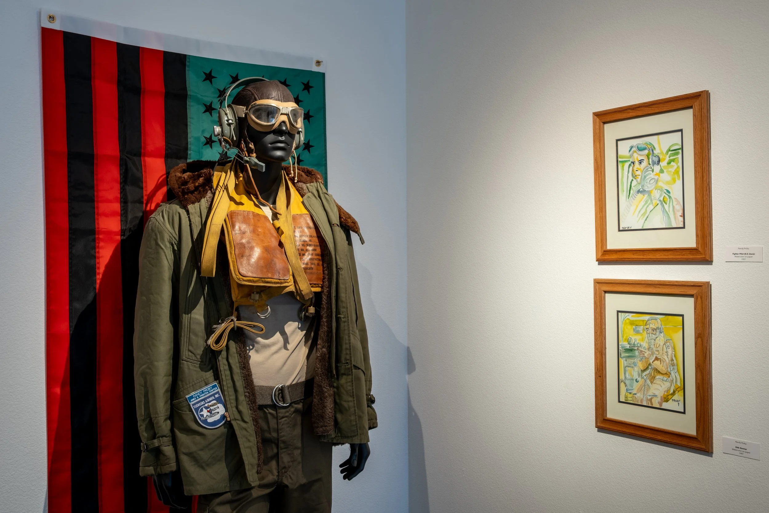 "Authentic Flight Gear of James B. Knighten" Courtesy the Collection of Randy Proby ; "Fighter Pilot (B.O. Davis)" and "Side Gunner" by Randy Proby, 1997