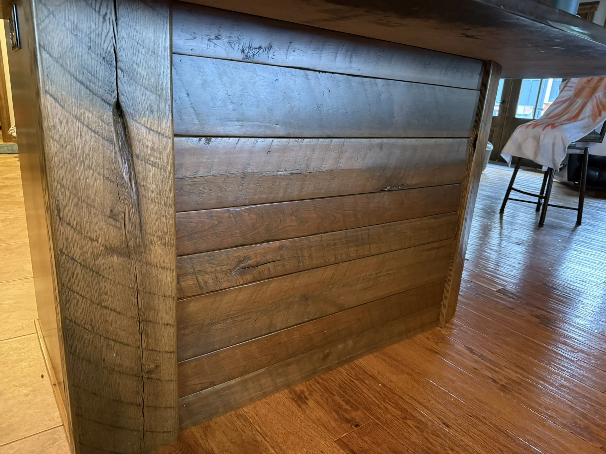 Rustic stained oak cabinet cladding with original saw marks
