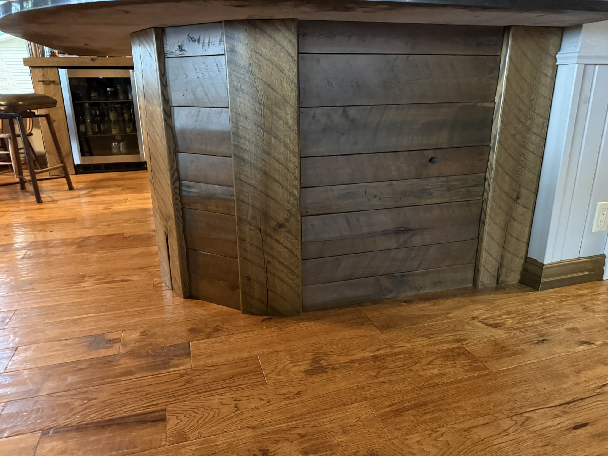 Rustic stained oak cabinet cladding with original saw marks