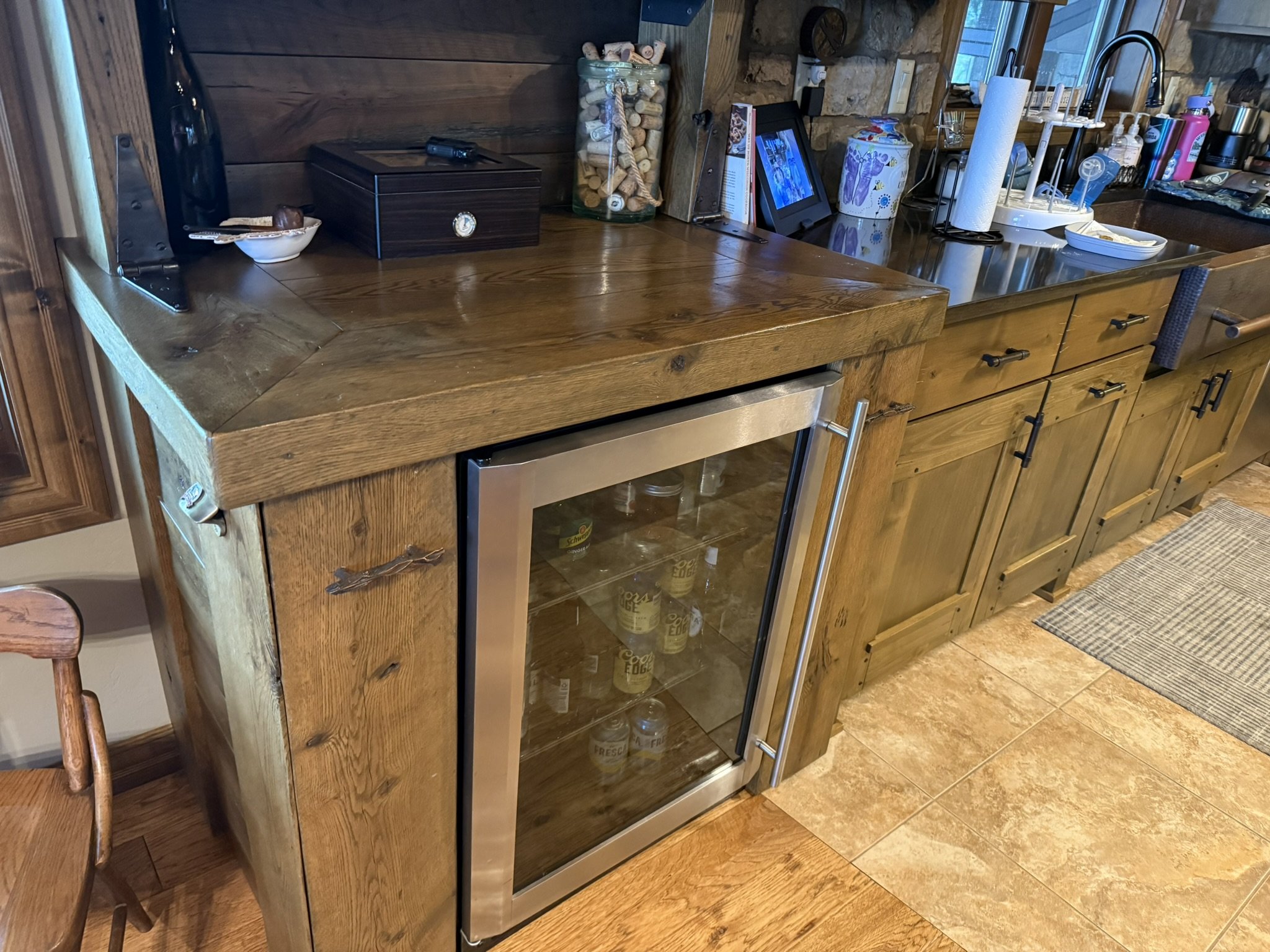 Rustic pine and oak dry bar with mini fridge compartment, shelves, and hidden side cabinets