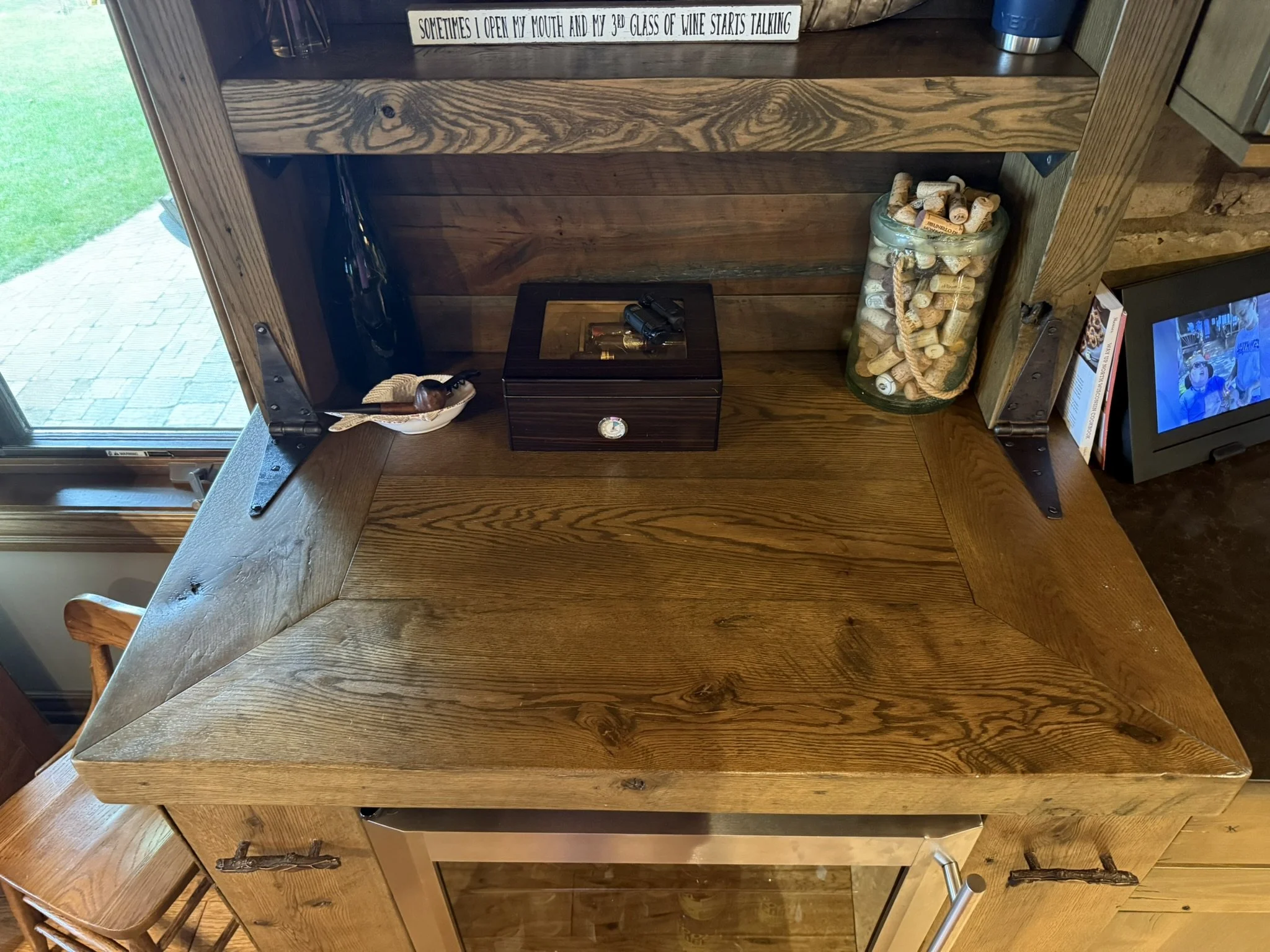 Rustic pine and oak dry bar with mini fridge compartment, shelves, and hidden side cabinets
