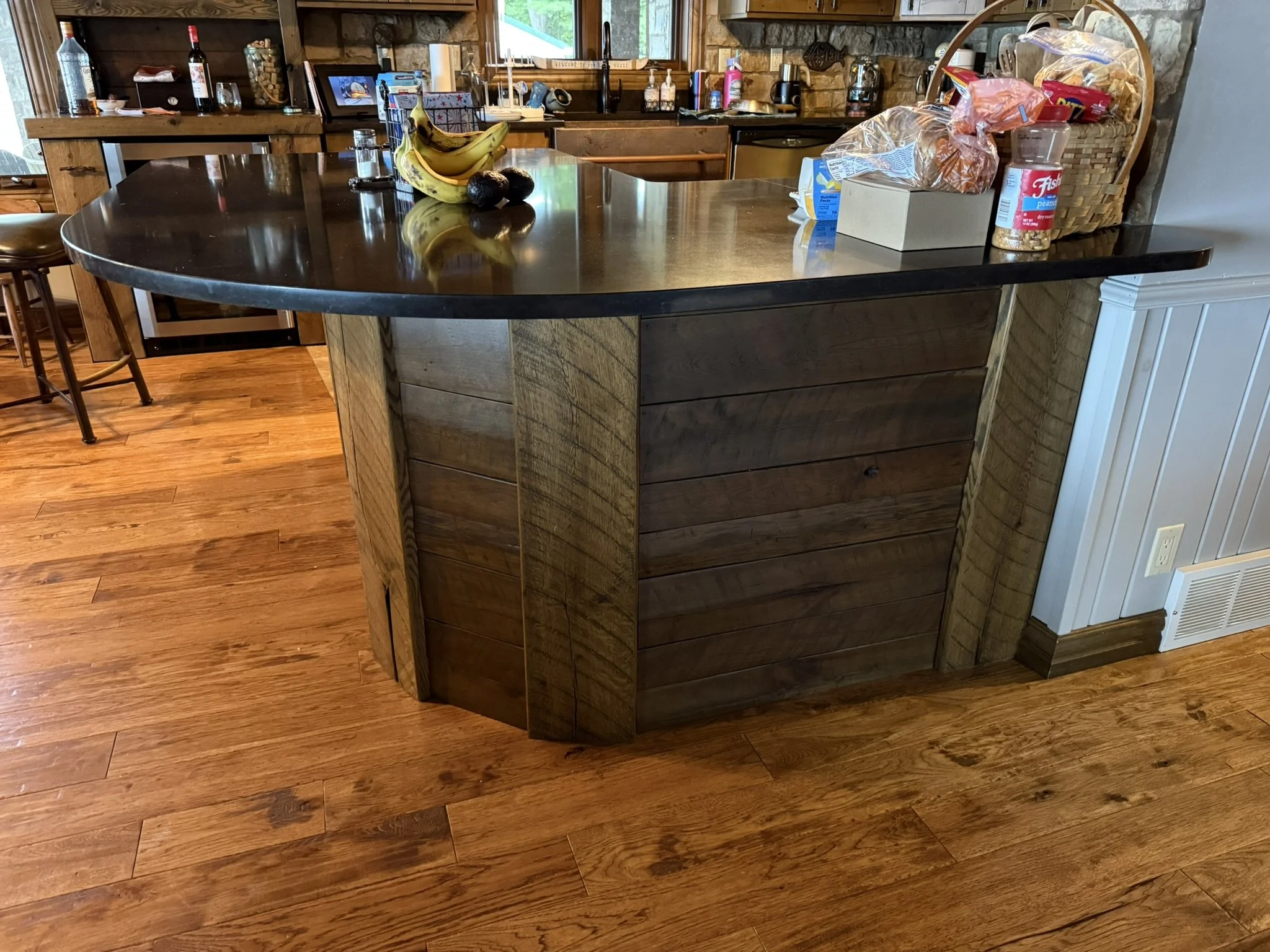 Rustic stained oak cabinet cladding with original saw marks
