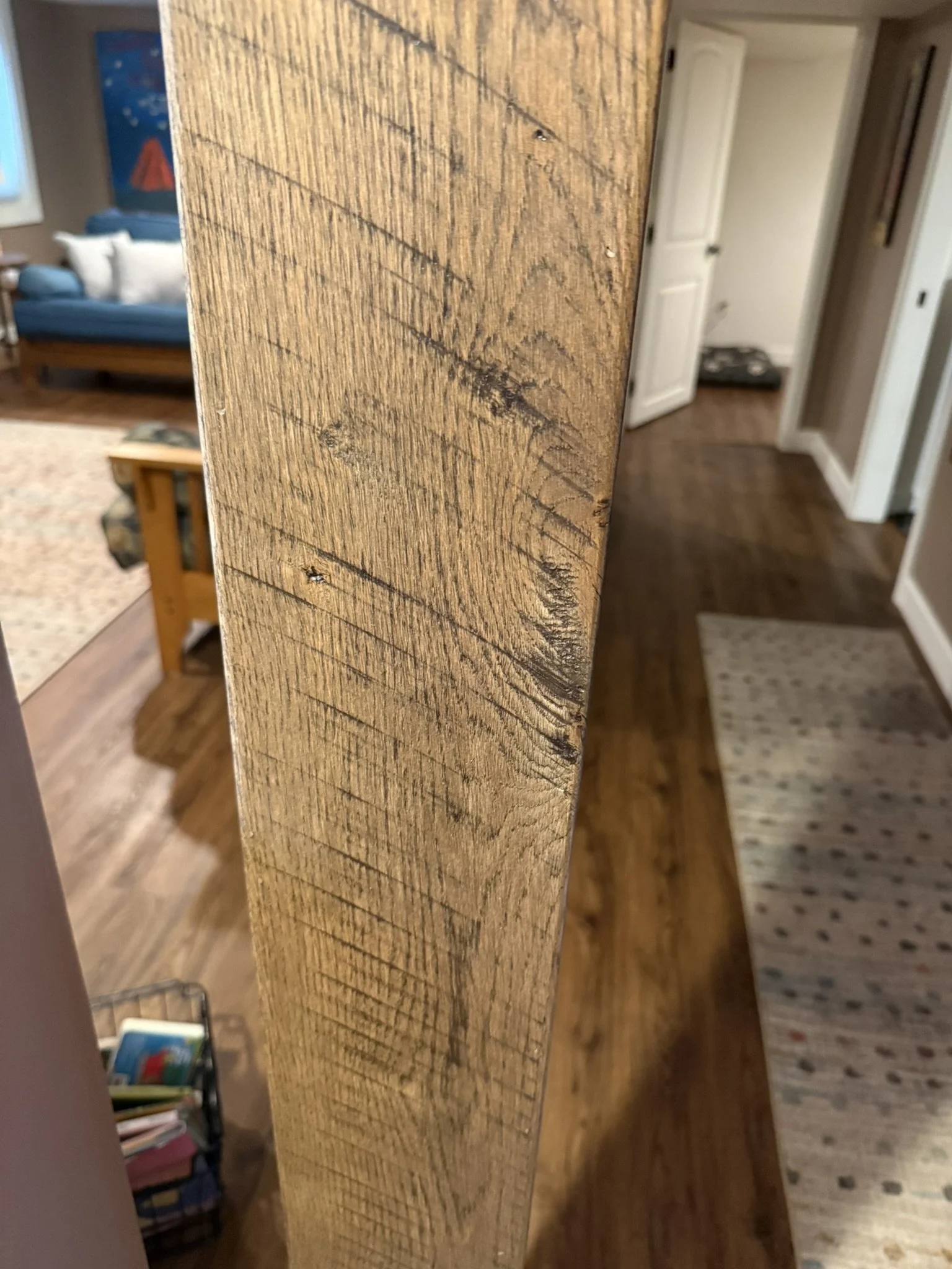 Rustic stained oak structural post cladding with original saw marks
