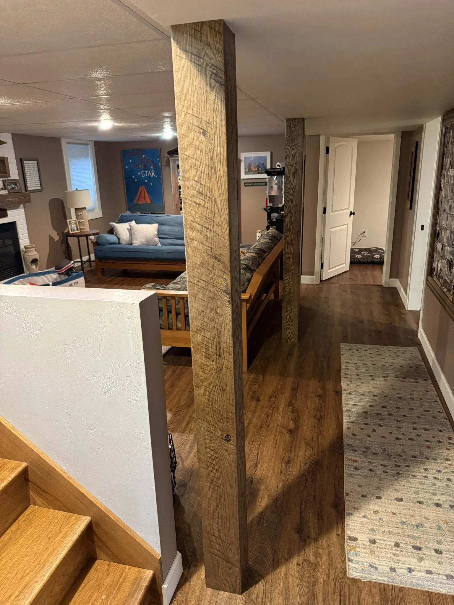 Rustic stained oak structural post cladding with original saw marks