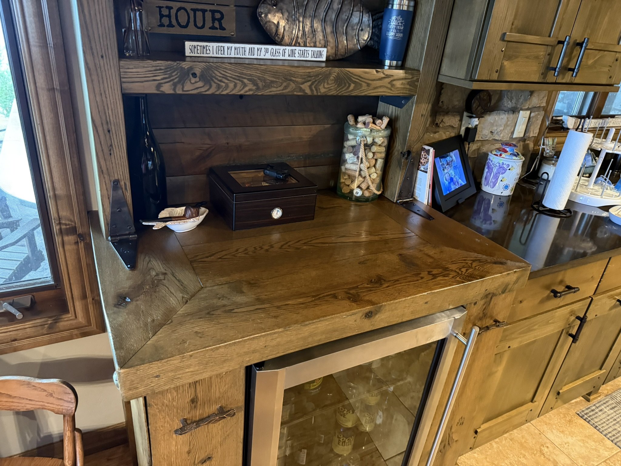 Rustic pine and oak dry bar with mini fridge compartment, shelves, and hidden side cabinets