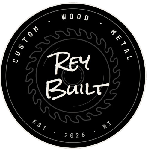 Circular logo with the text 'Rey Built' in the center, surrounded by the words 'Custom,' 'Wood,' 'Metal,' 'EST 2026,' and 'WI,' with a saw blade design encircling the text.