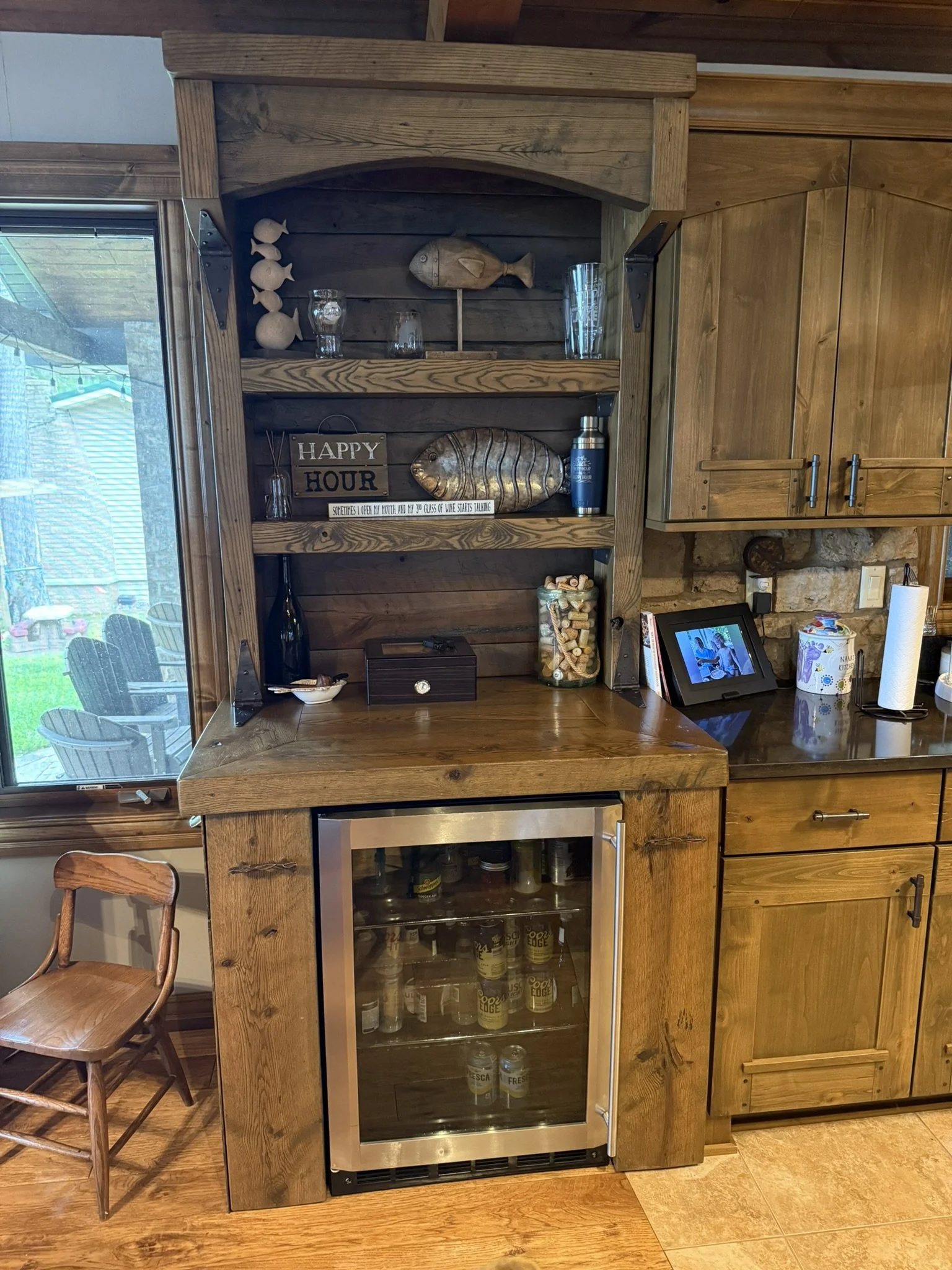 Rustic pine and oak dry bar with mini fridge compartment, shelves, and hidden side cabinets