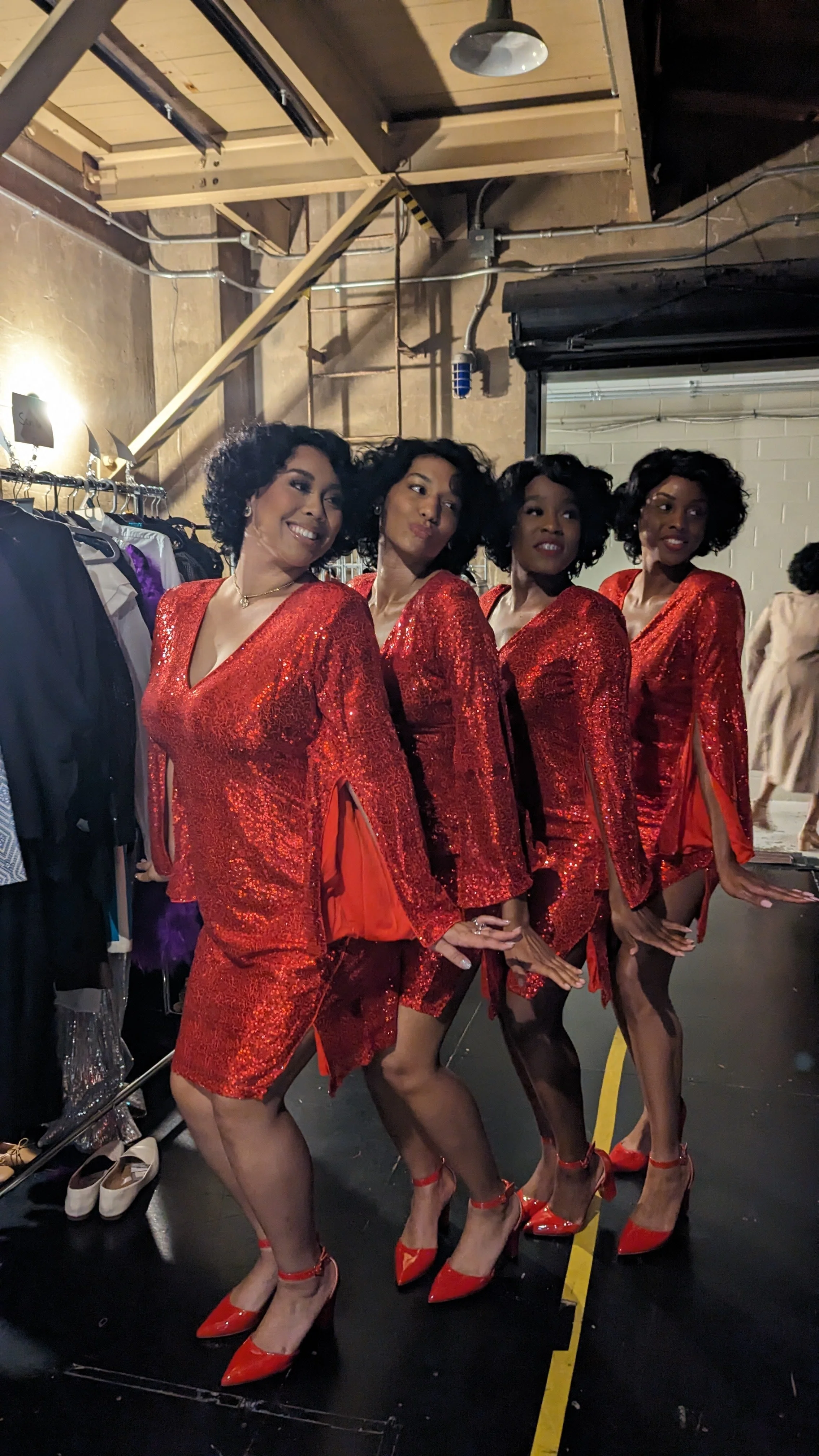 Four women in red sequins dresses