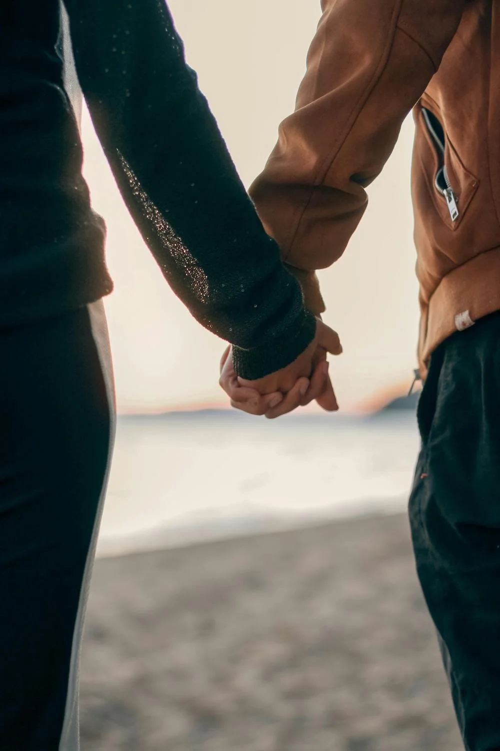Couple holding hands outdoors, representing healing and reconnection