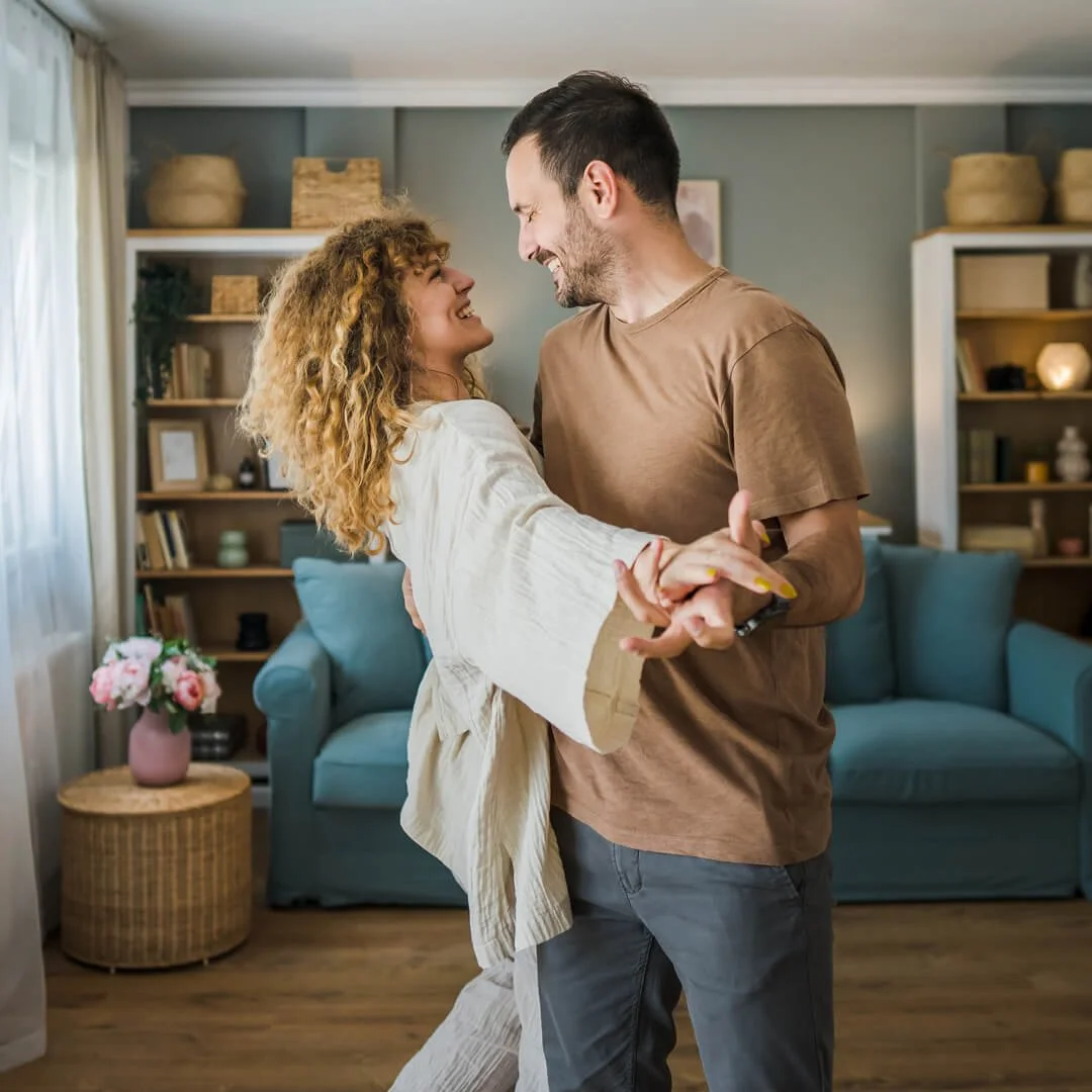Couple smiling and reconnecting during a positive moment at home