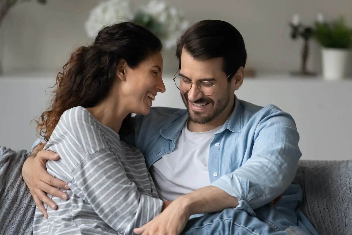 Couple sharing a lighthearted moment after strengthening their relationship through therapy