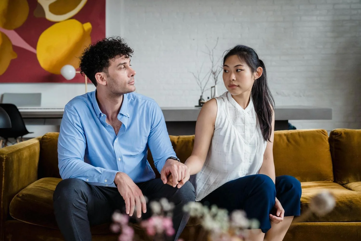 Couple holding hands gently while navigating uncertainty in their relationship