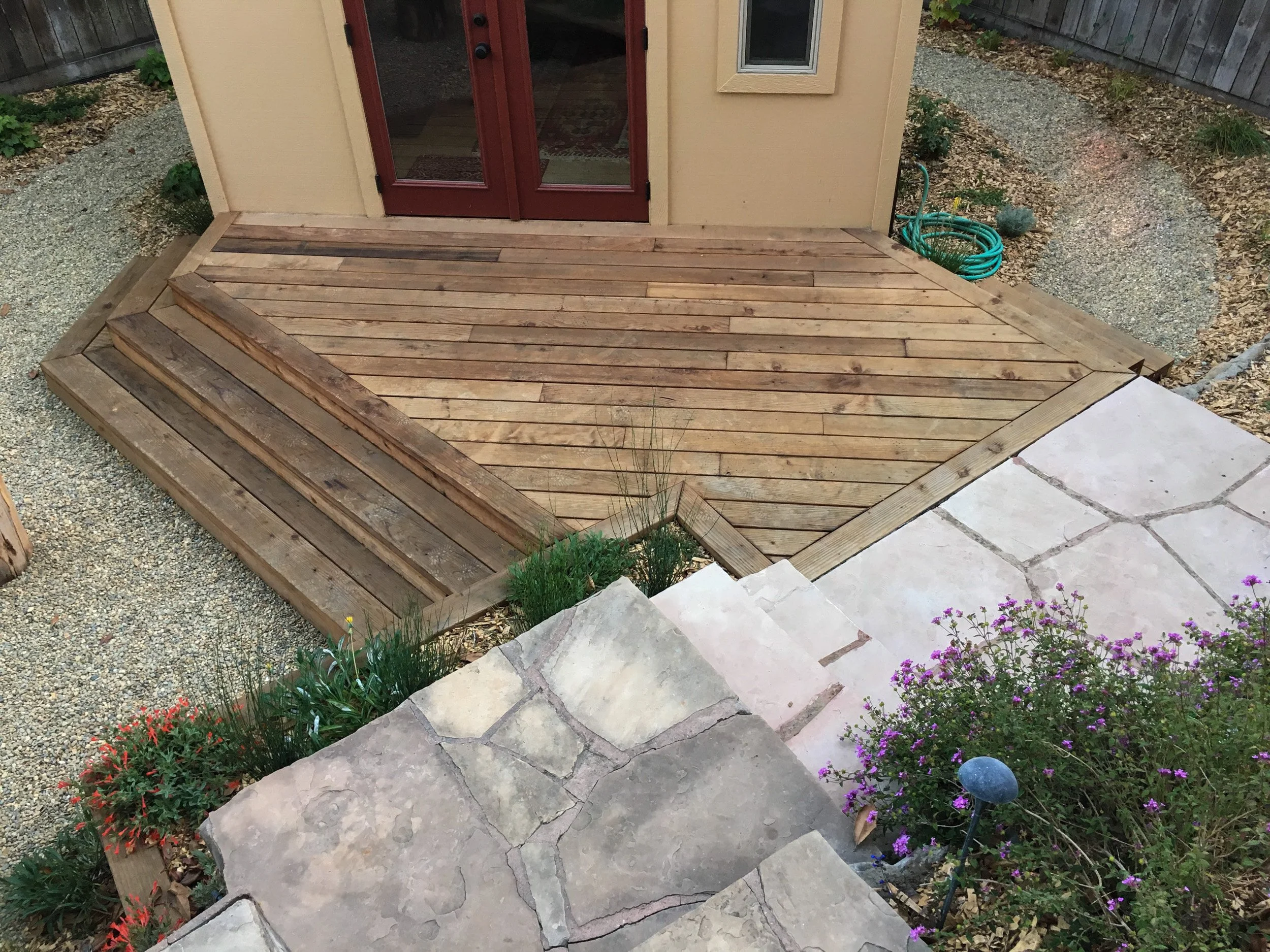 Wood deck connected to mortared flagstone steps in front of ADU