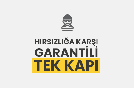 A sign with a cartoon burglar figure and a message in Turkish that warns against theft, indicating a guaranteed single door lock.