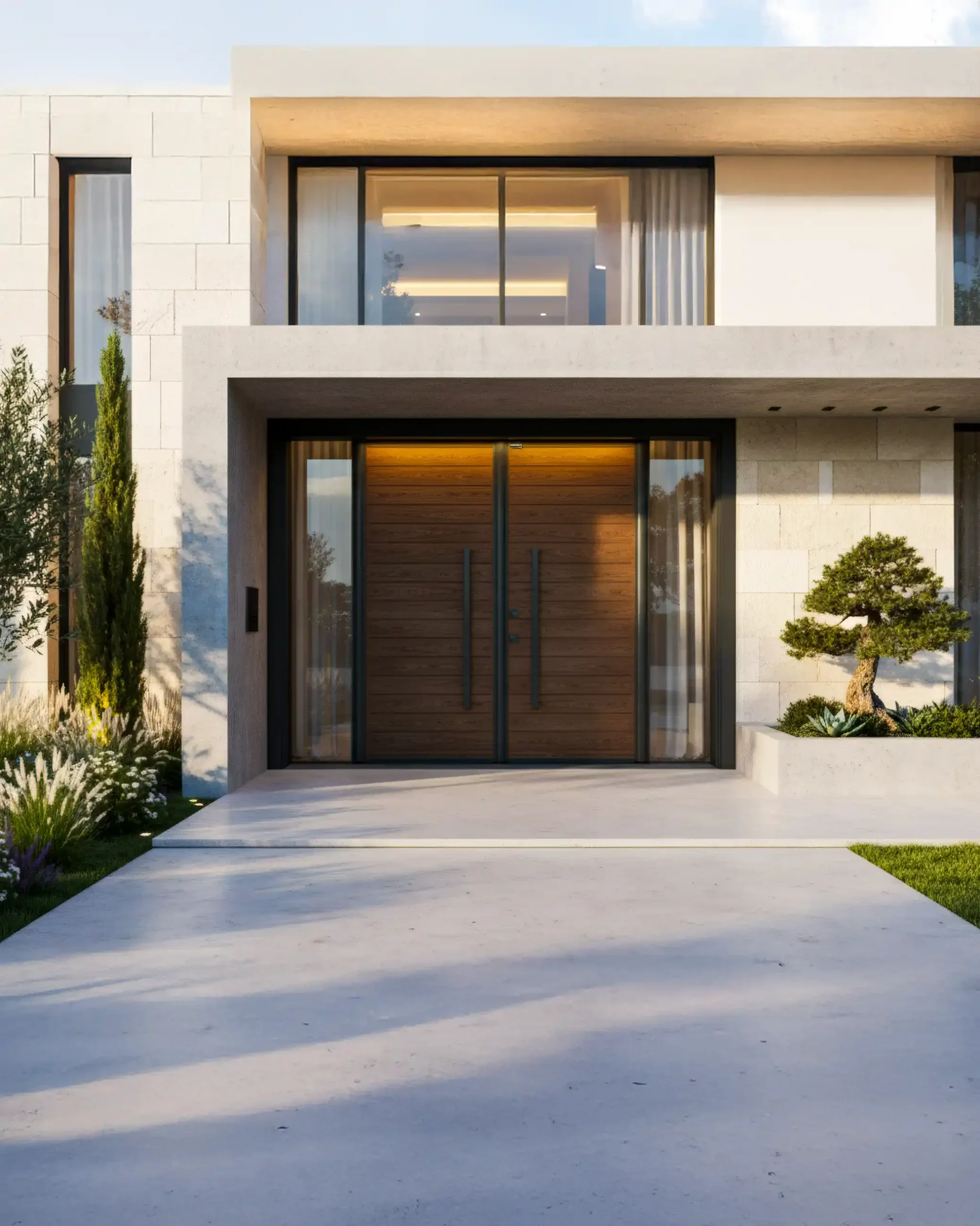 Modern house entrance with wooden double doors, glass panels, a small landscaped garden, including a bonsai tree, and a concrete driveway.