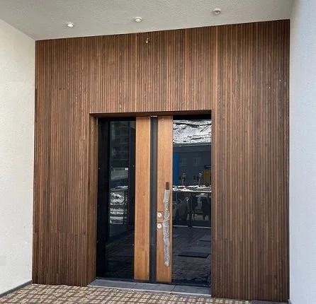 Entrance with wooden door and glass panels in a modern building