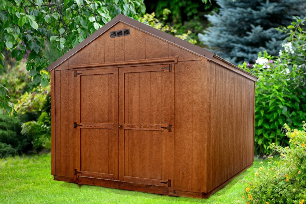 Wooden garden shed with double doors in a backyard surrounded by green foliage and a grassy lawn.