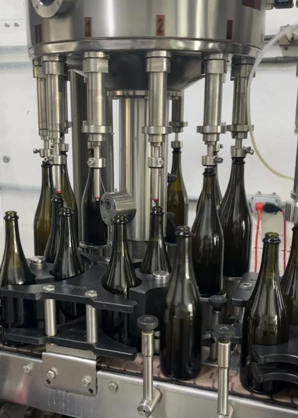 AERILYN 2024 vintage sparkling wine bottles moving through the tirage bottling line at C2 Cellars in Orcutt, California