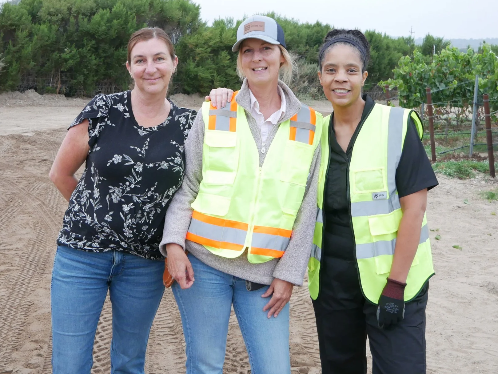 Tammee Thompson of AERILYN Wine Co. with Alisa Jacobson and viticulturist Shannon Gledhill in a Sta. Rita Hills vineyard after completing the first pick of the 2026 harvest.