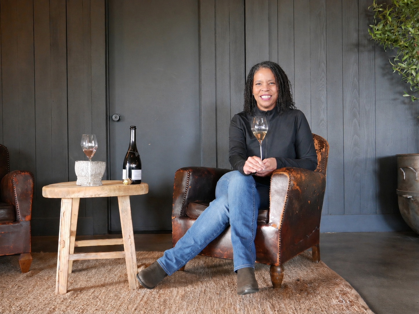Tammee Thompson at home with a glass of AERILYN.