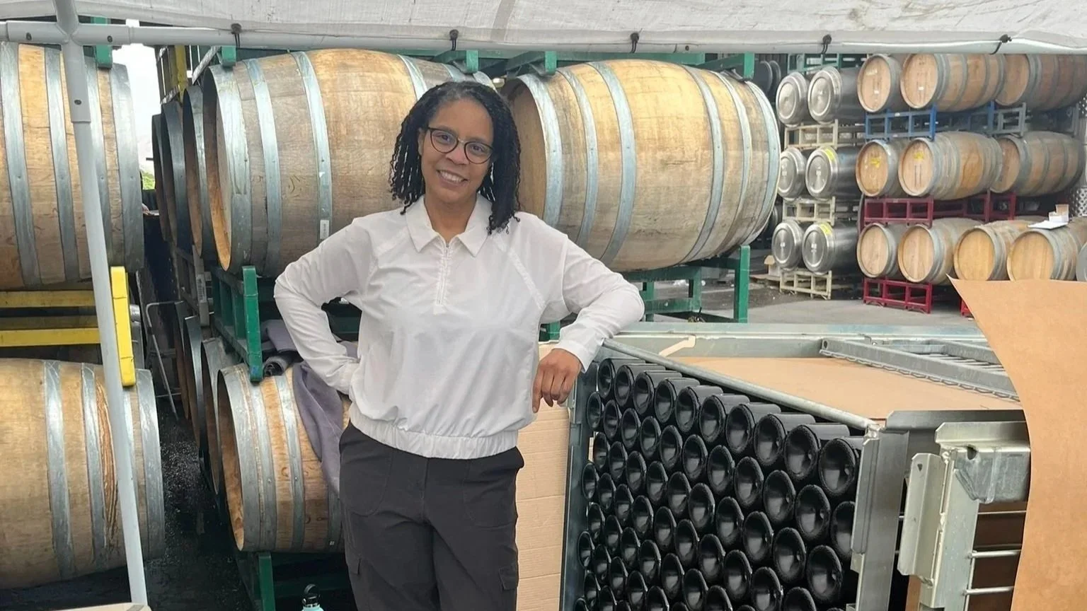 Tammee Thompson standing beside the tirage cage on bottling day for AERILYN's inaugural 2024 vintage.