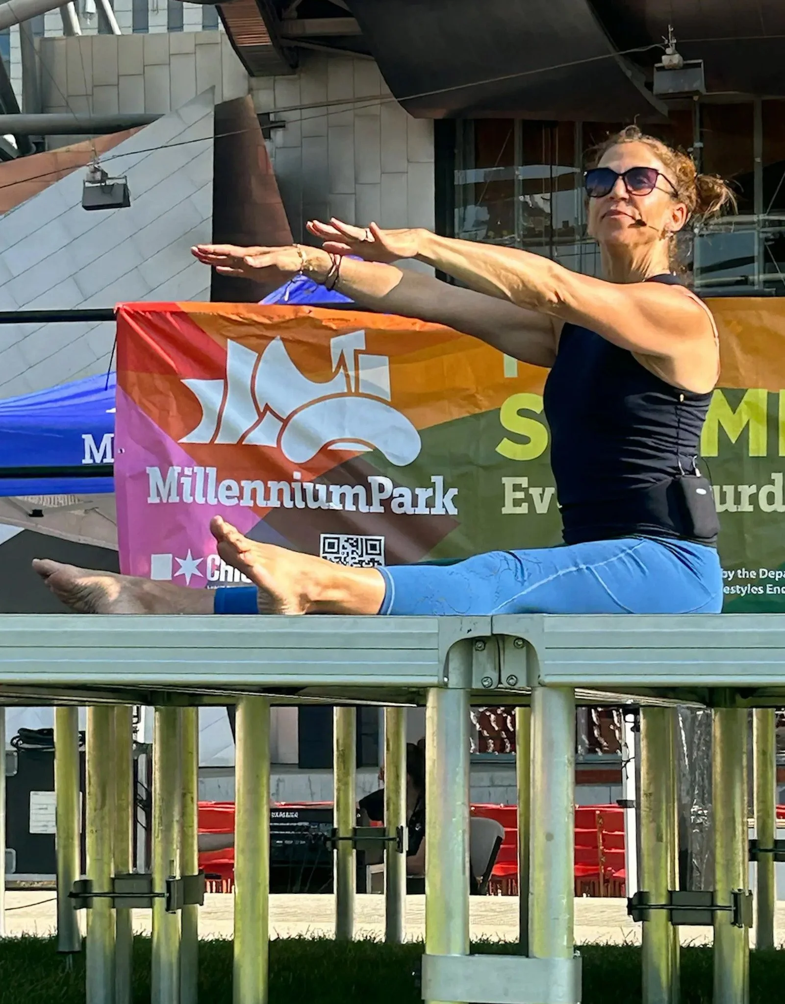 Frog Temple Owner Randi Whitman leading a Pilates Mat Class i Millennium Park, Chicago, Illinois.