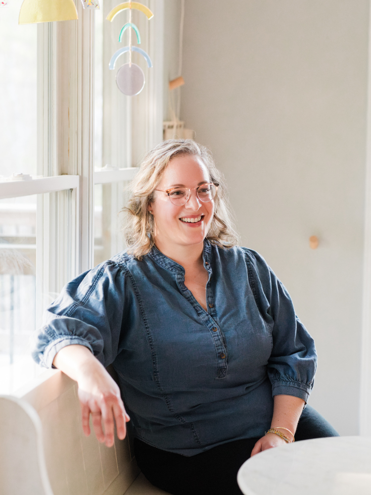 Mollie Stephens, organizational consultant and founder of Matter Collaborative, laughing in a light-filled space — reflecting the warm, candid leadership development work she does with nonprofit and public sector teams.