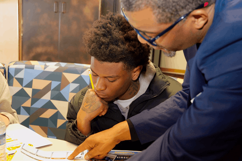 student reviewing papers with Jeremy