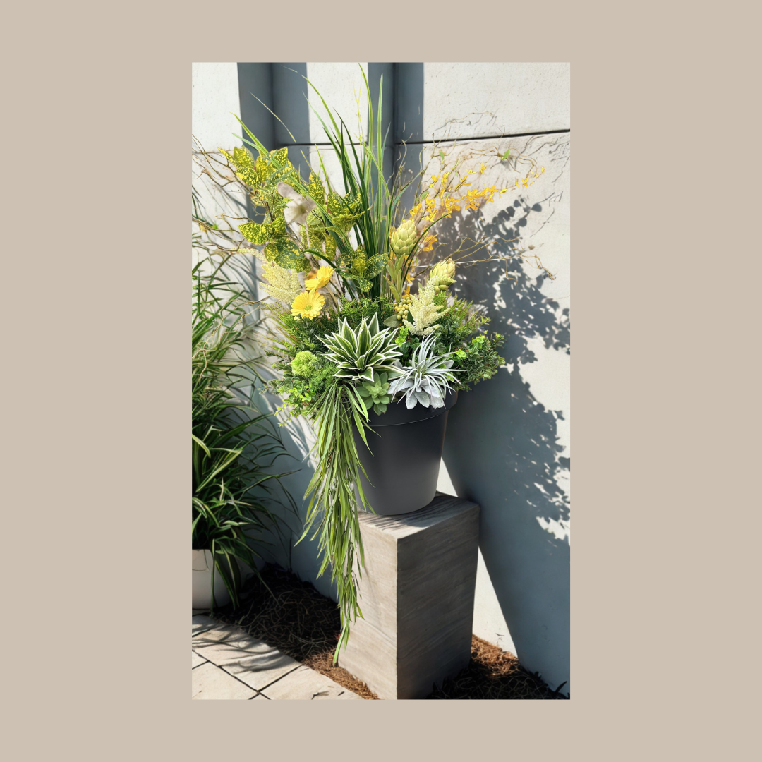 Large Planter with Greens and Yellows on a pillar.png