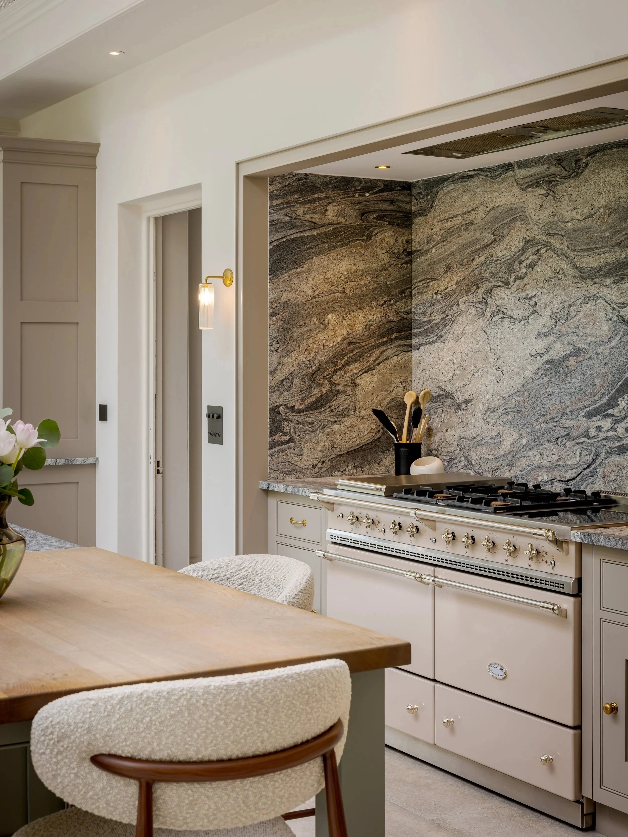 Close view of the natural-stone splashback and wall lighting in the Albury Road kitchen.