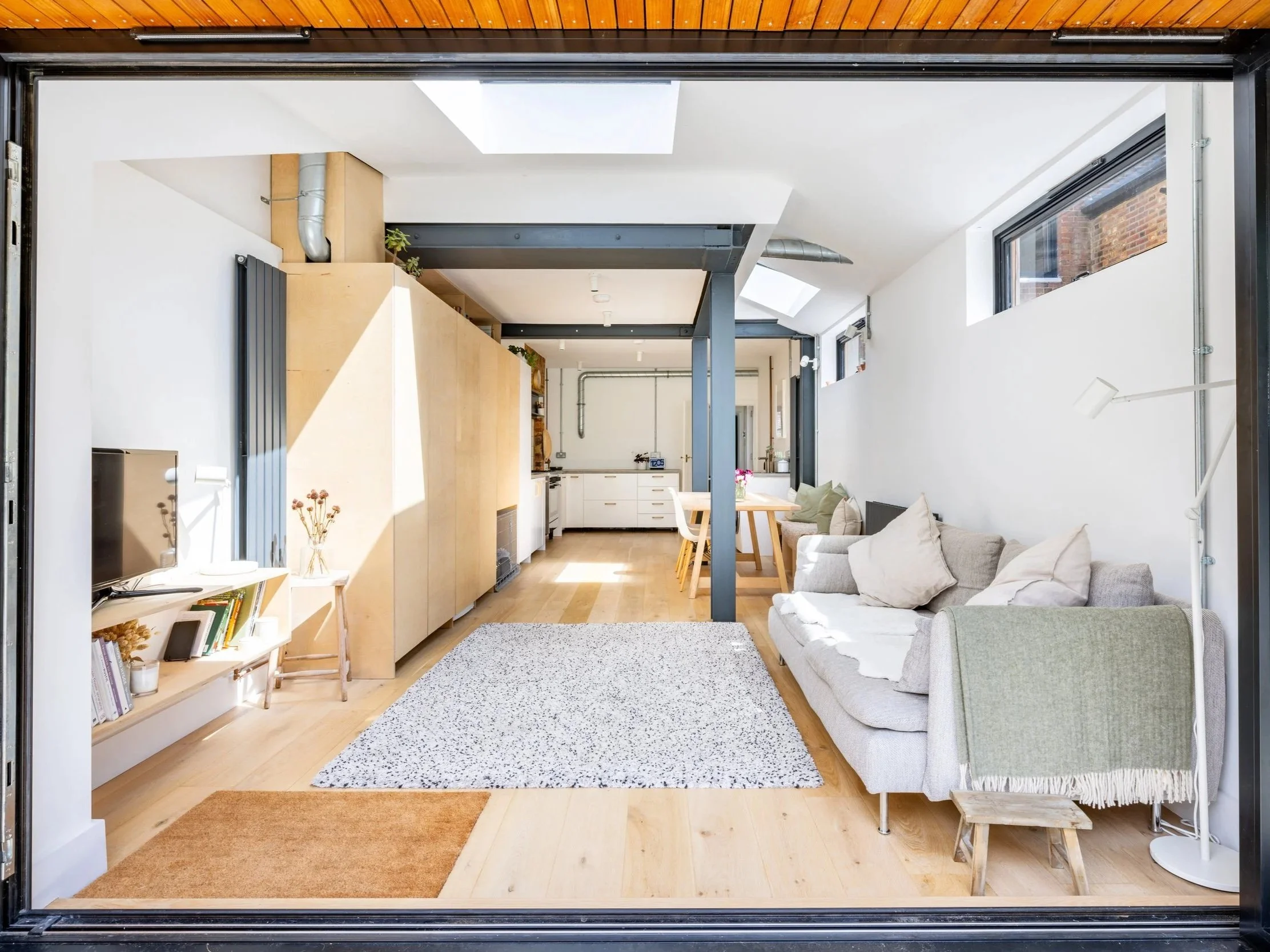 View from the terrace through open doors into the living area and kitchen.