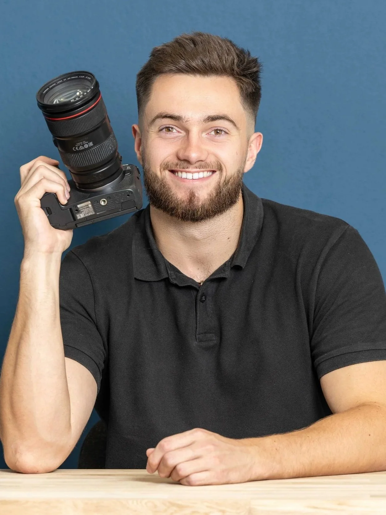 Tom Joslin, founder of TSJ Media, holding a camera.