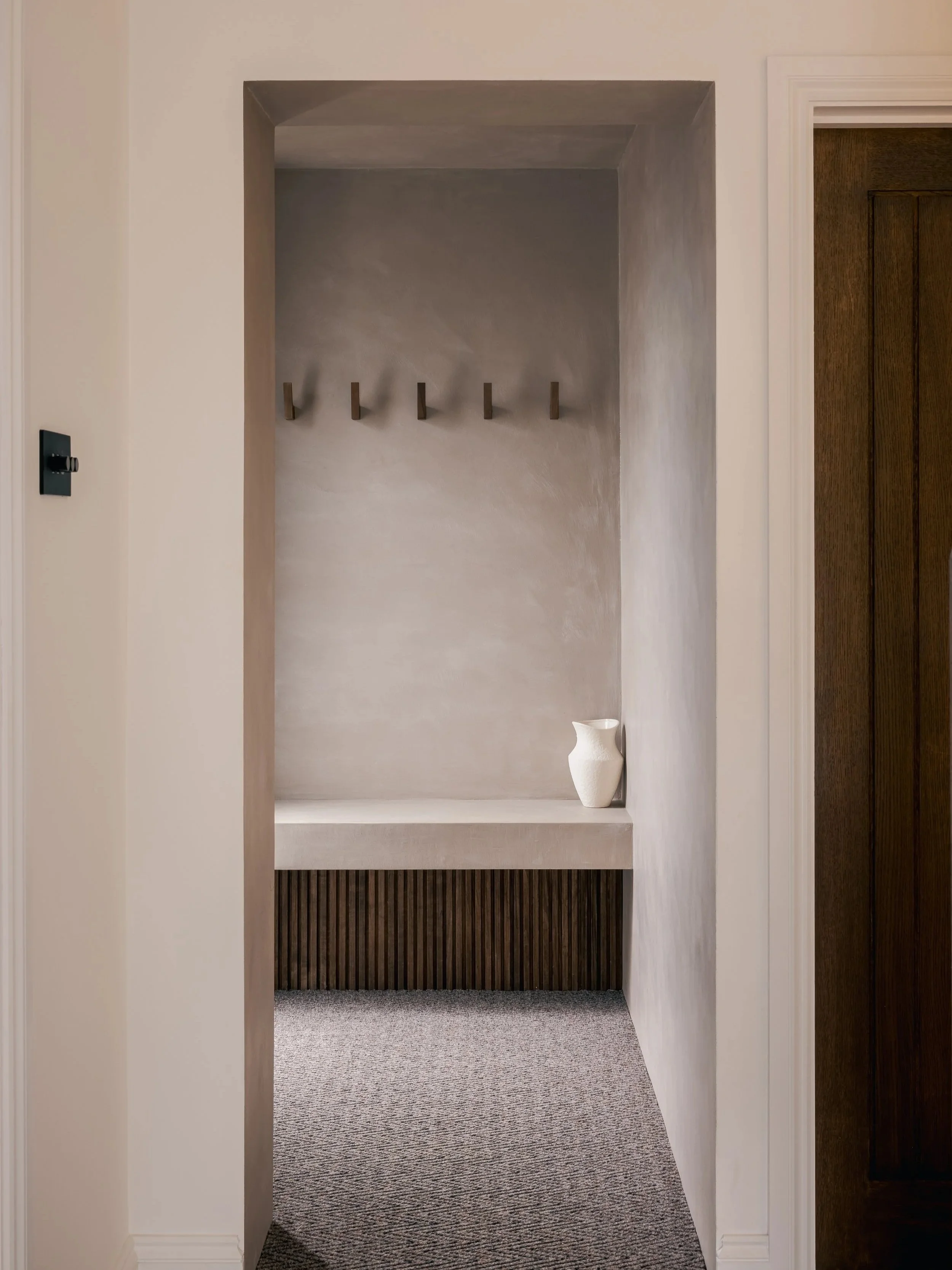 View through a doorway to a bedroom with a built-in wardrobe at Elwood House.
