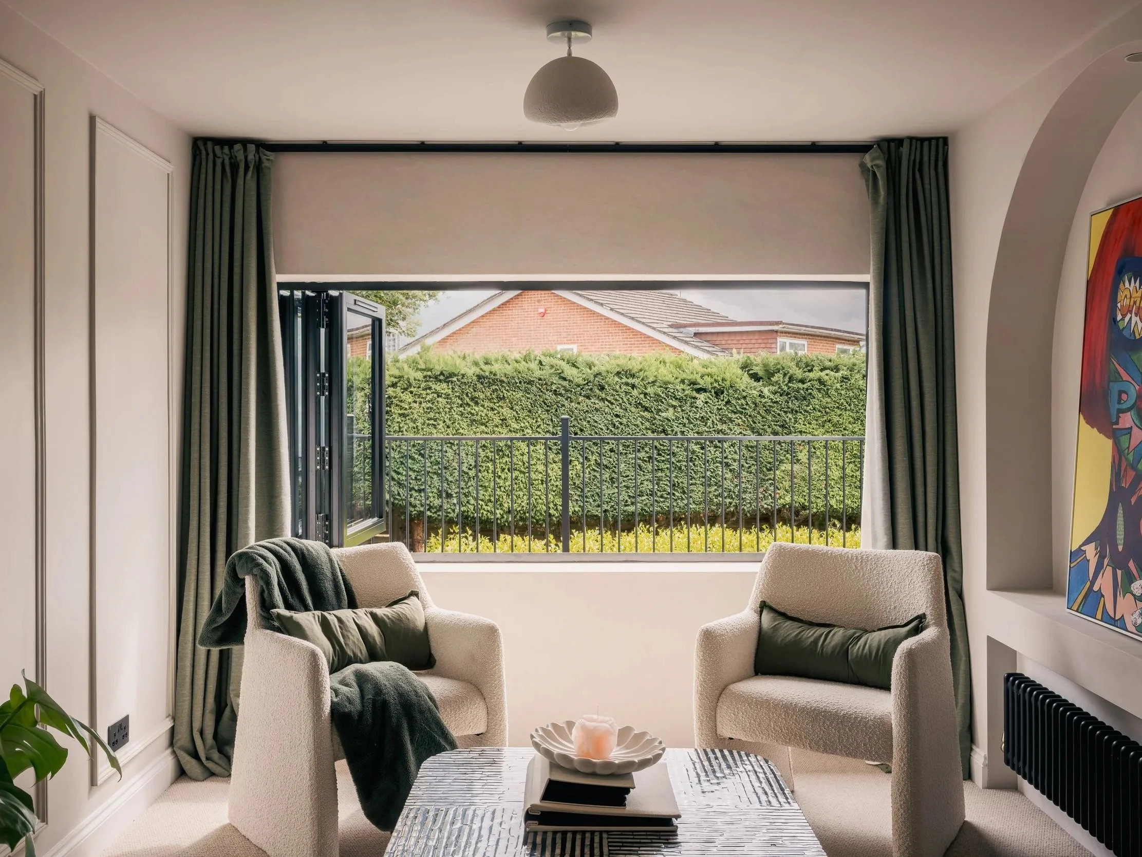 Living room at Elwood House with a bay window framing views of the garden.