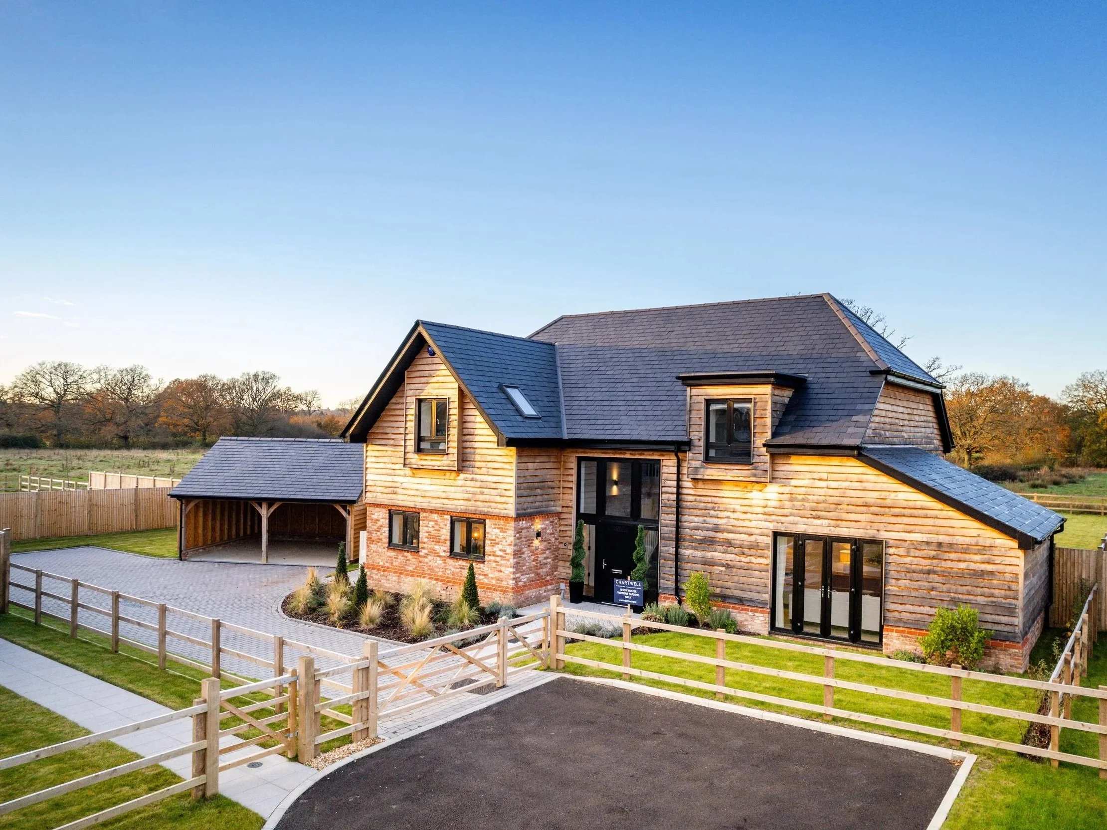 Detached brick home at Oldencraig Mews with a driveway, front lawn and countryside setting.