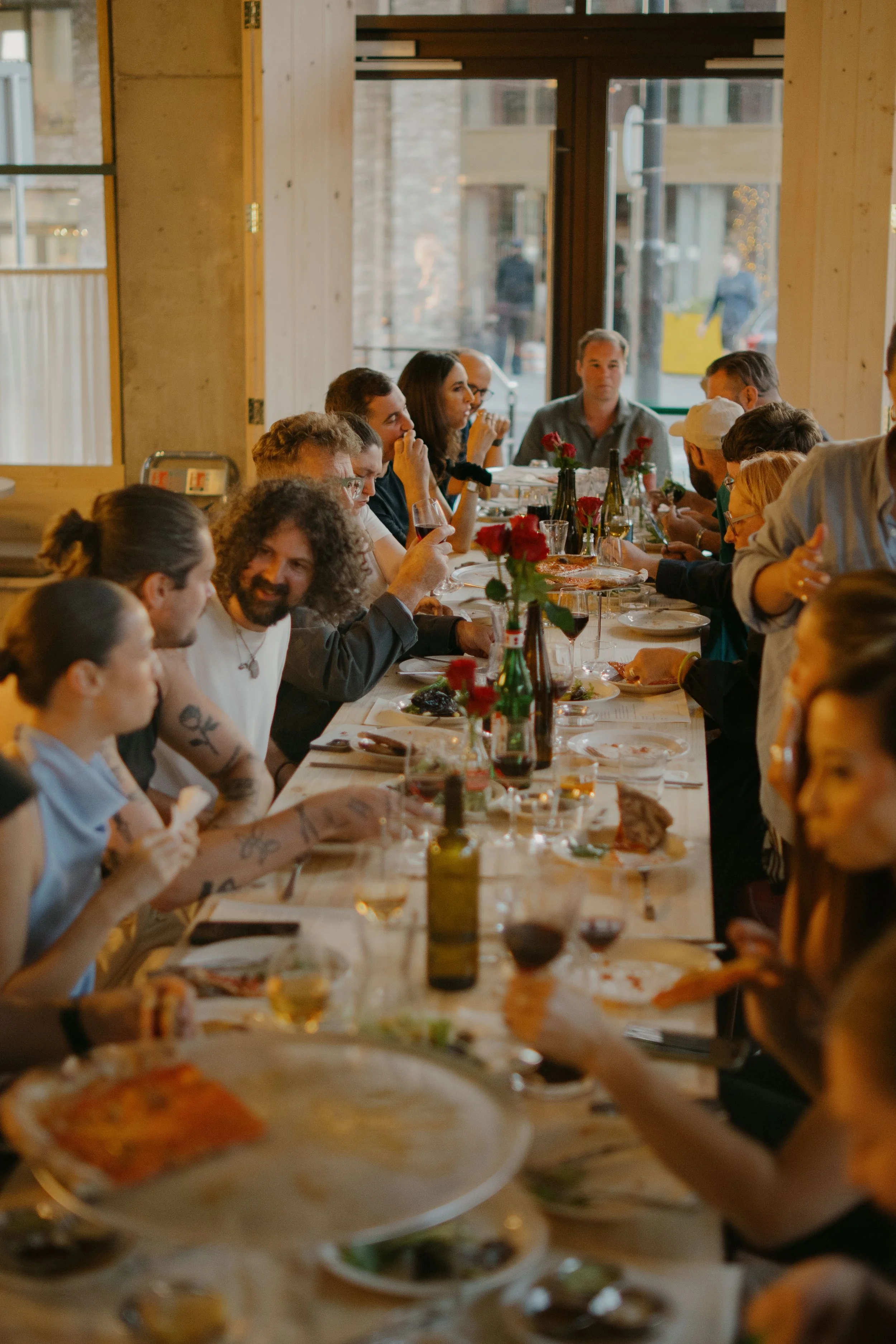 Guests sharing a meal at Proloco in Ancoats, Manchester.