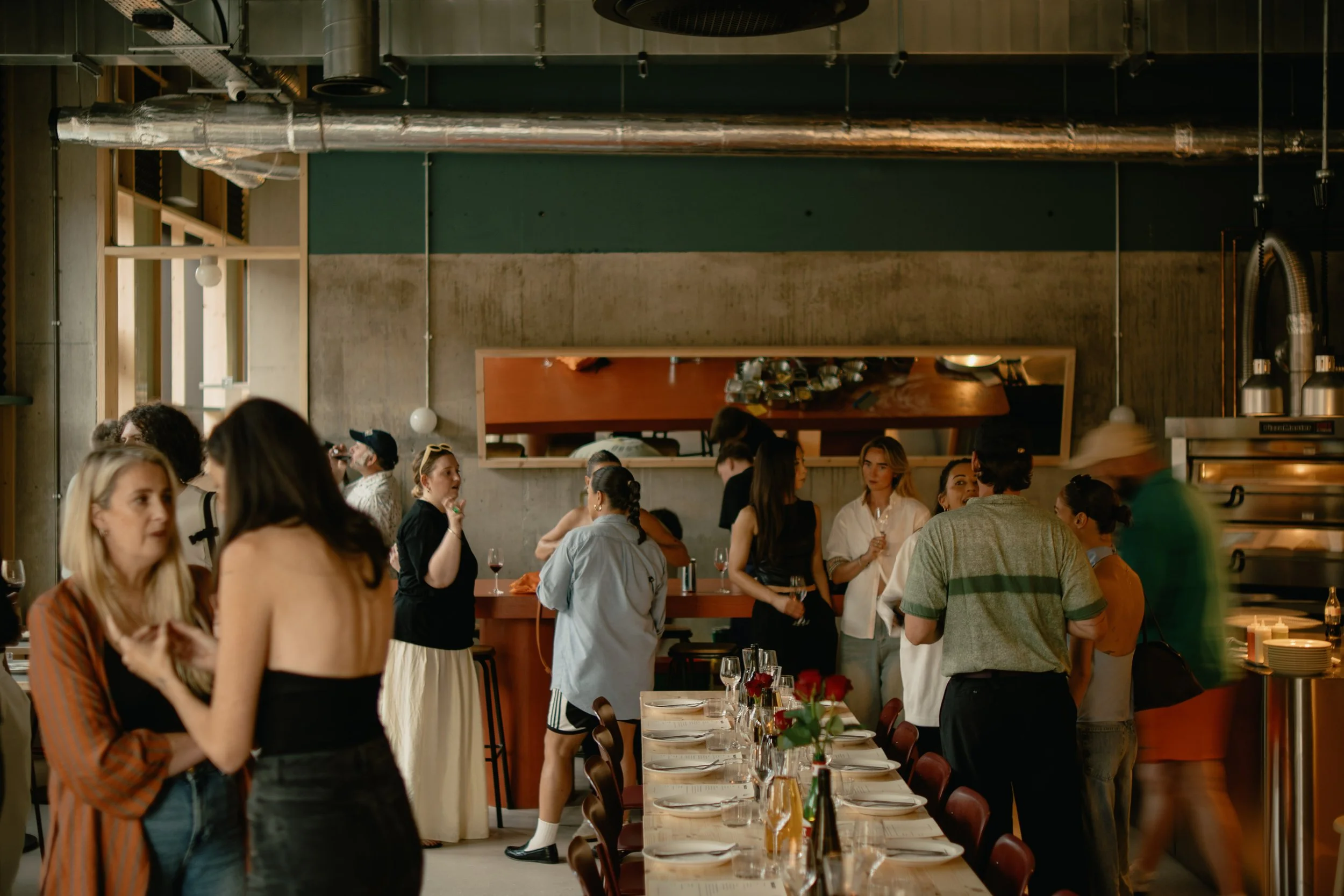 Guests mingling at a group event at Proloco, Ancoats