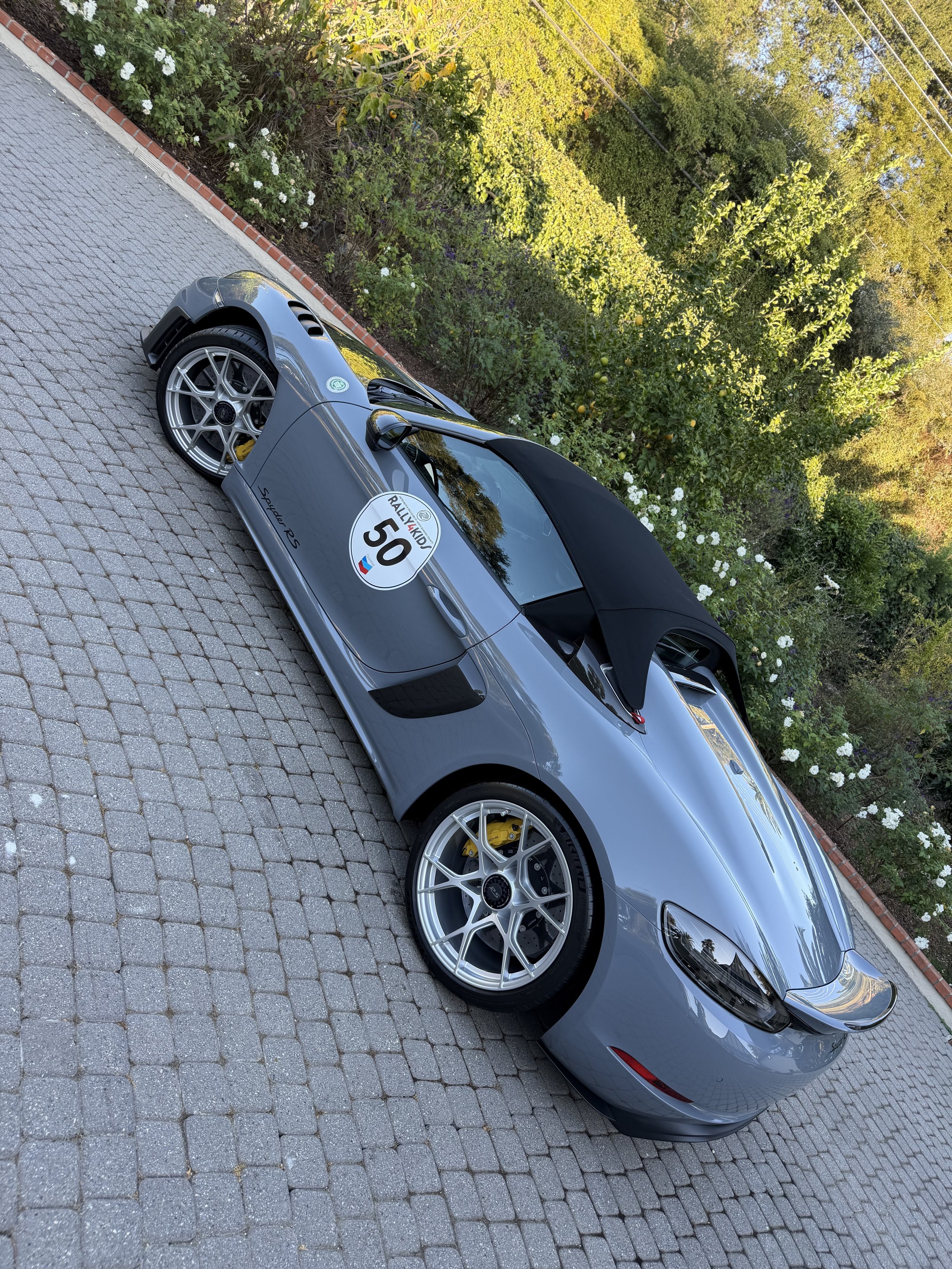 gray-porsche-convertible-number-50-parked-on-cobblestones--e445f14f.jpeg