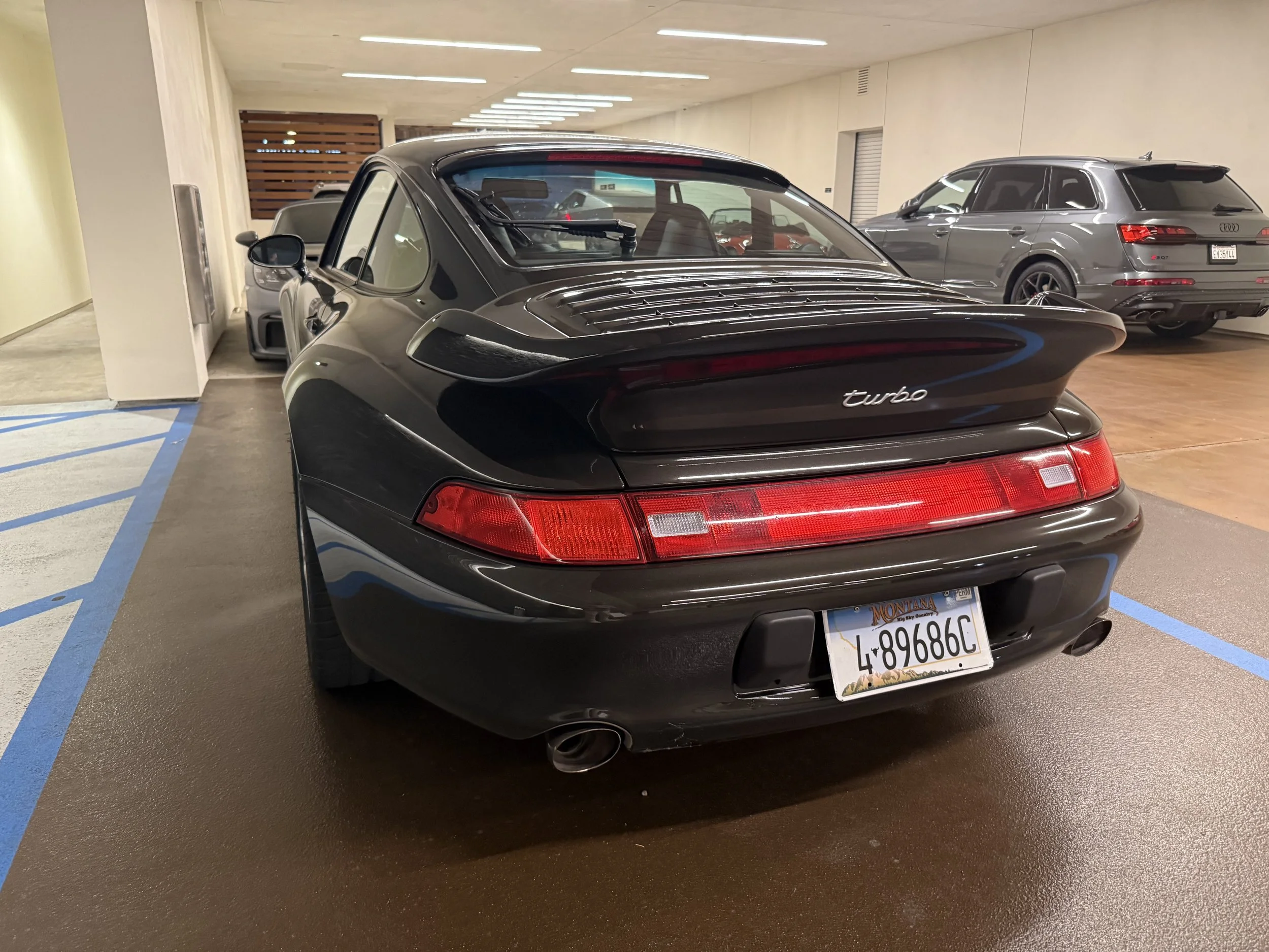 rear-view-of-a-black-turbo-sports-car-in-a-garage--b2156035.jpeg