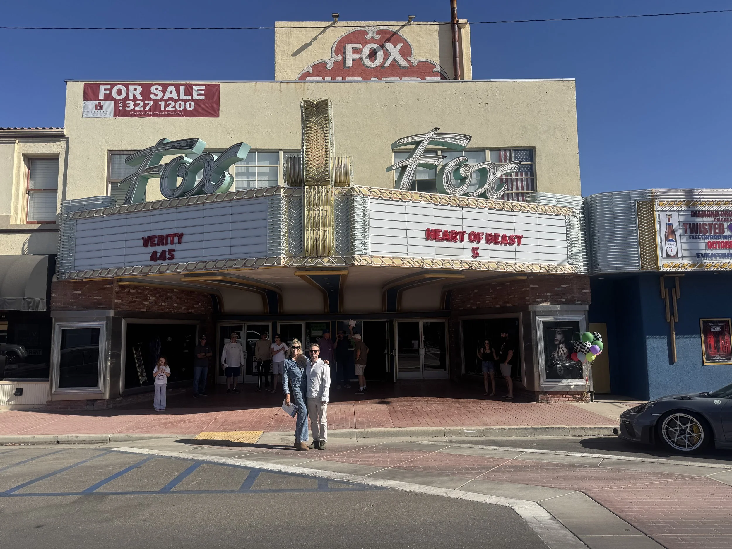 two-people-standing-in-front-of-the-fox-theatre-marquee--23b71a2d.jpeg