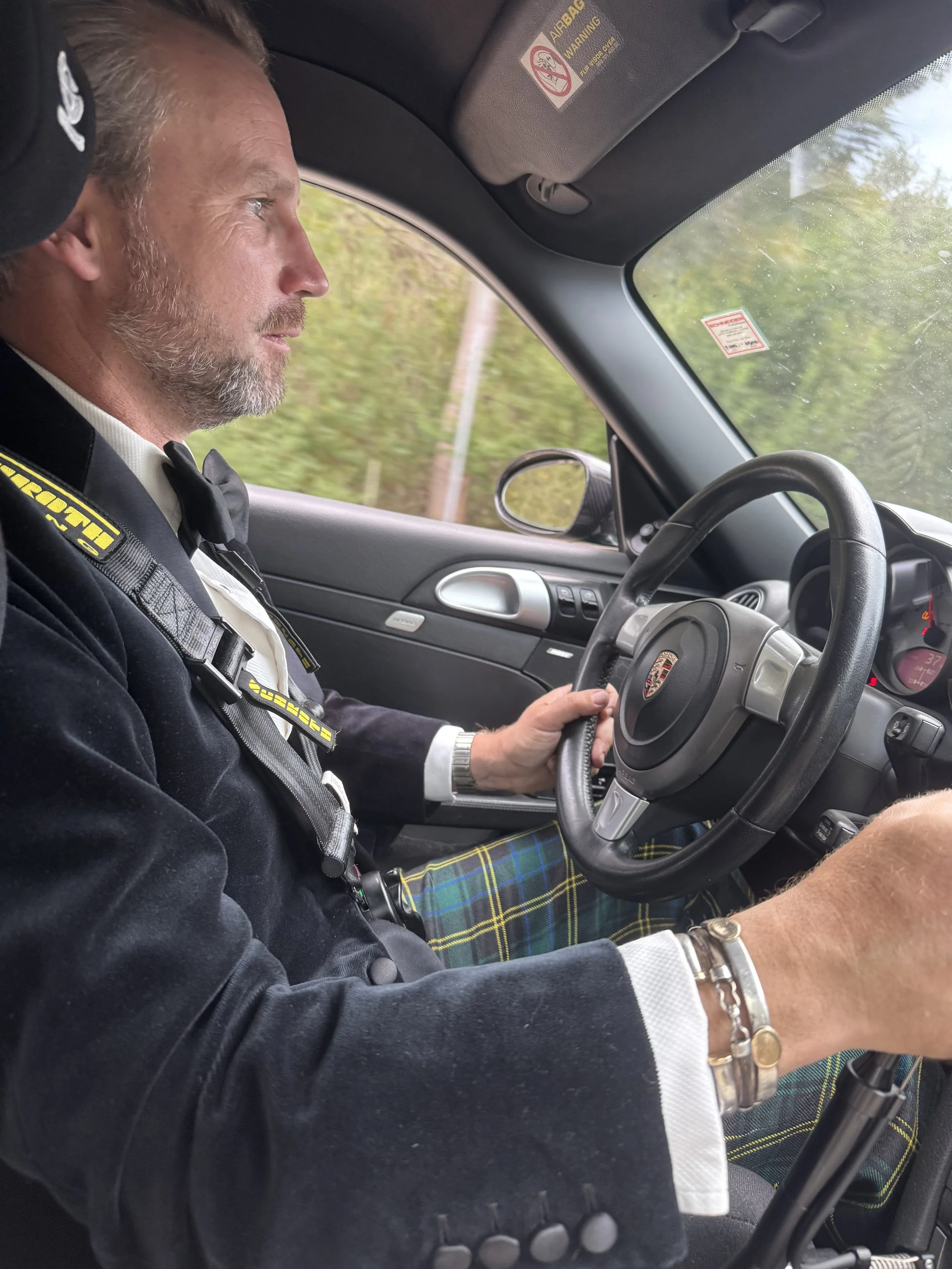 man-in-kilt-driving-porsche-with-yellow-harness--64bd86b4.jpeg
