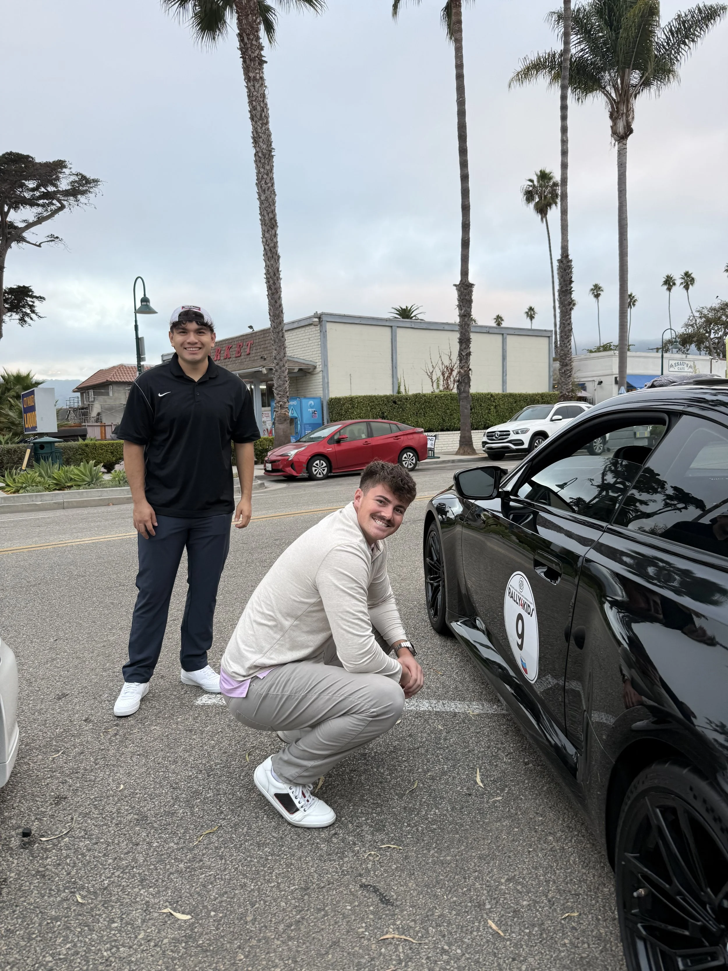 two-men-near-black-car-with-number-9--783f466a.jpeg