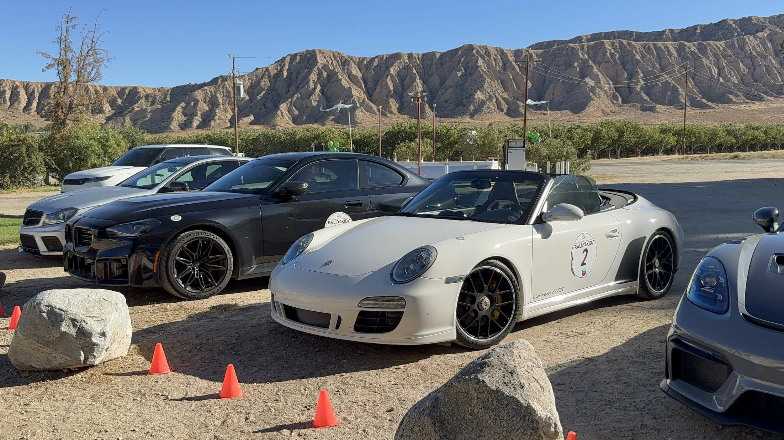white-porsche-convertible-with-rally-number-2-parked-in-desert--eccc2d99.jpeg