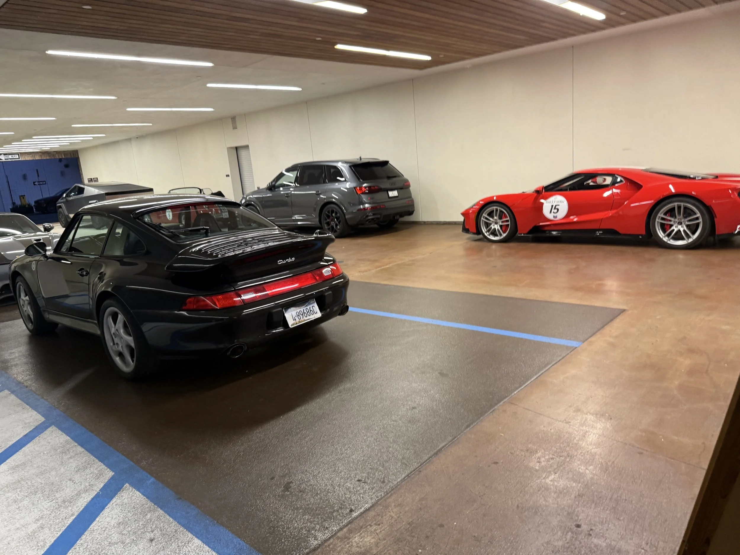 black-coupe-and-red-race-car-with-number-15-in-garage--acbb5f6c.jpeg