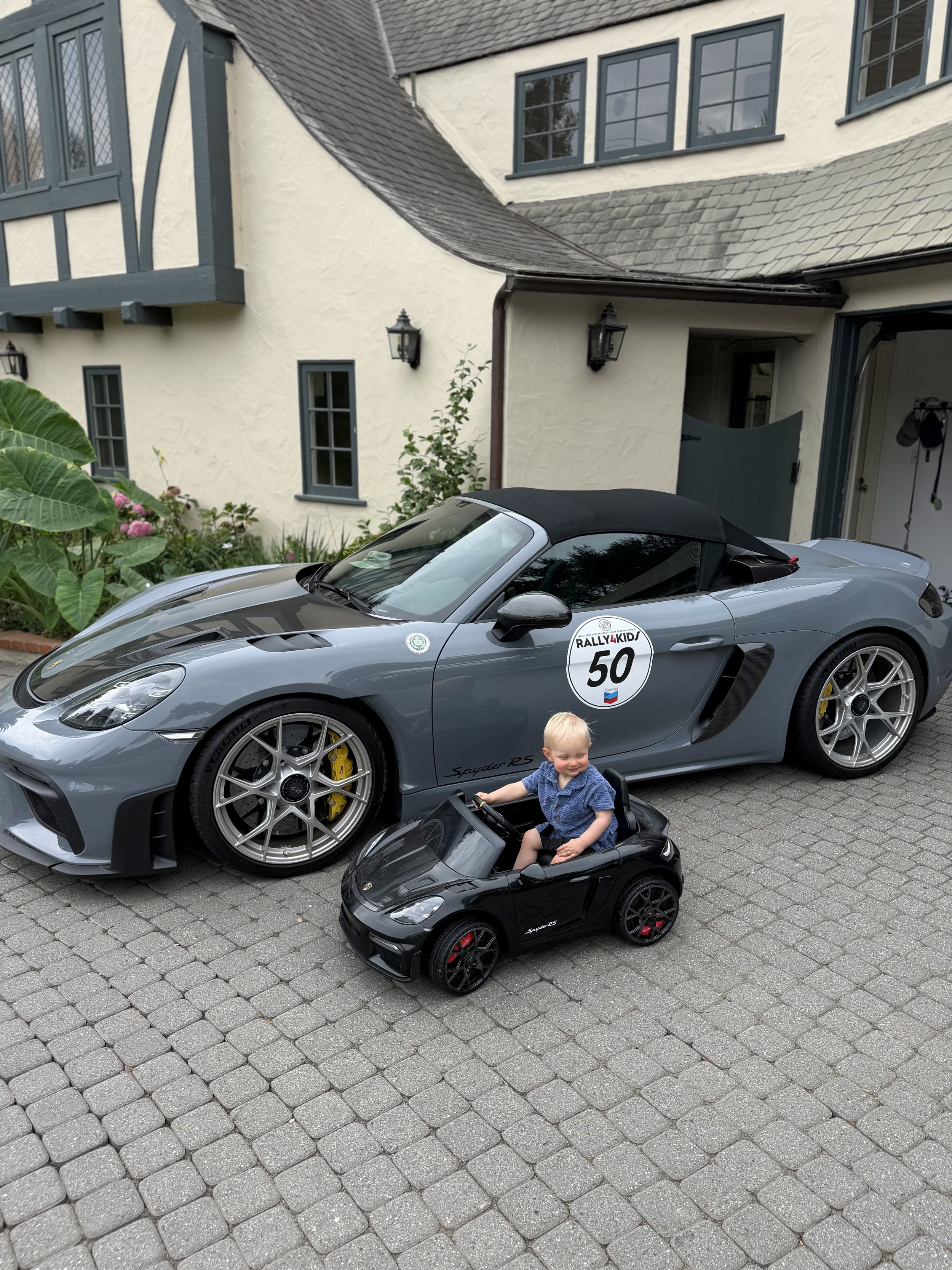 toddler-in-blue-shirt-driving-black-toy-car--5093686c.jpeg