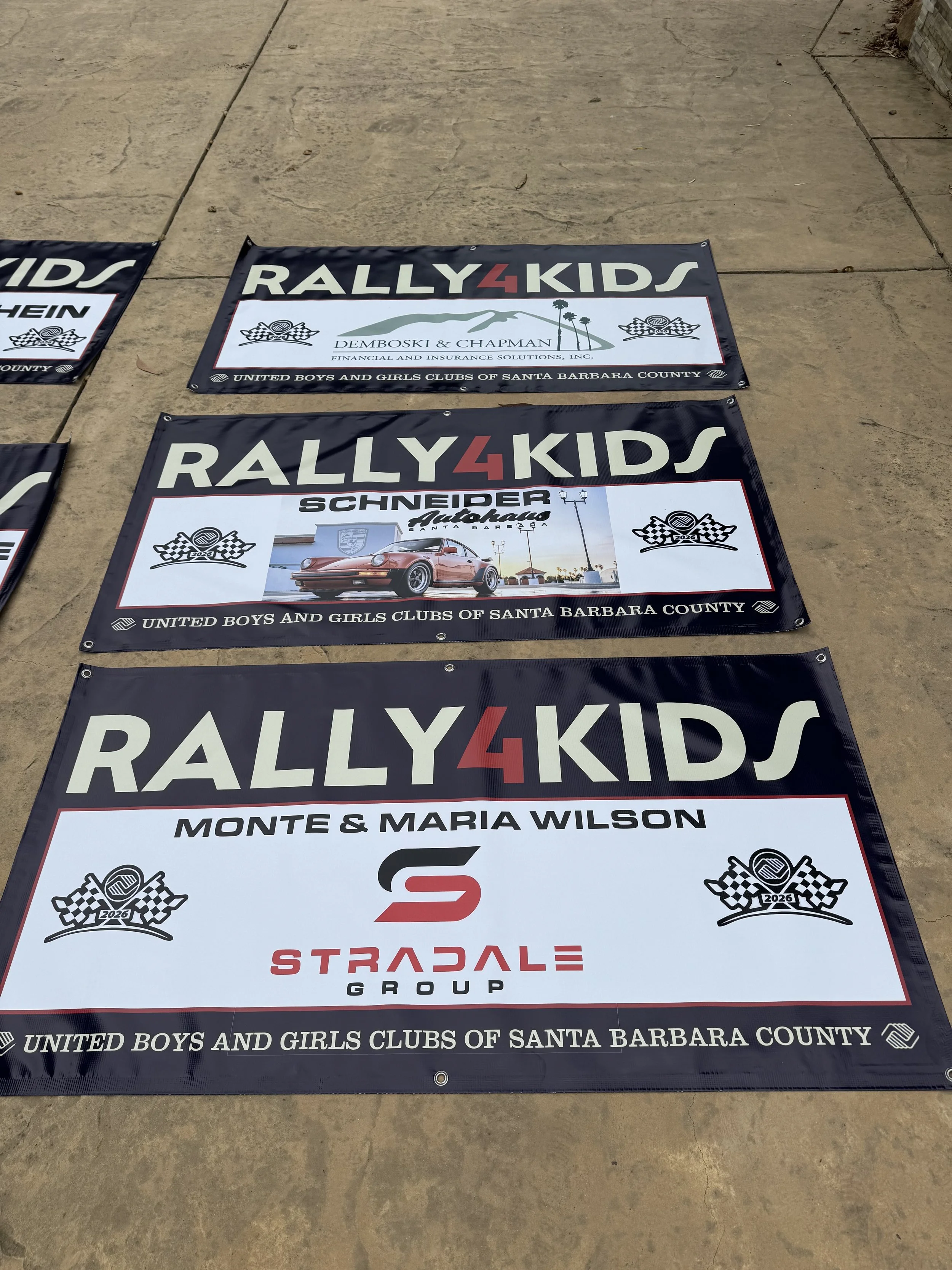 three-rally4kids-banners-laid-on-concrete-ground--715bbbac.jpeg