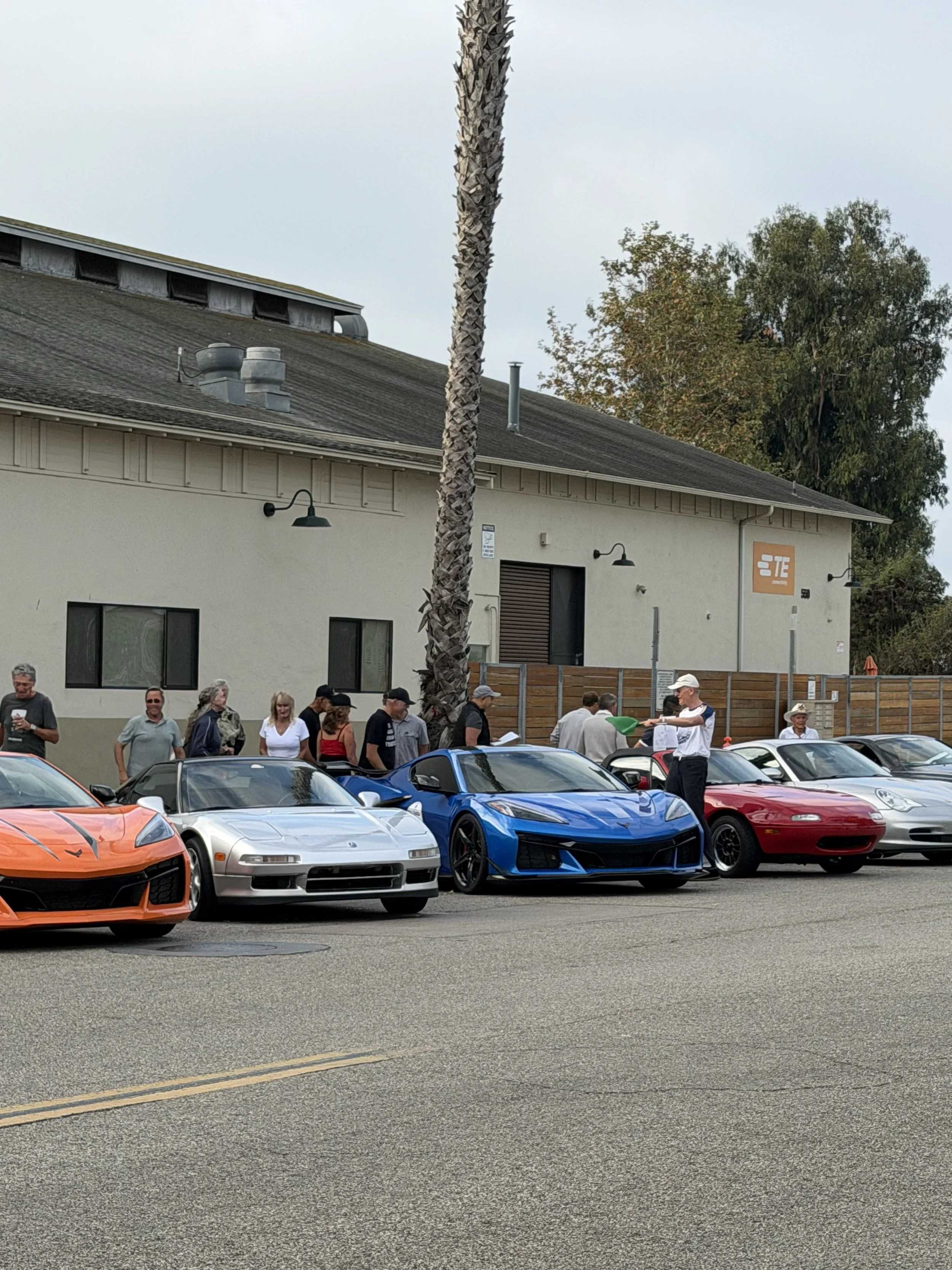 spectators-behind-orange-silver-blue-and-red-sports-cars--82f64838.jpeg